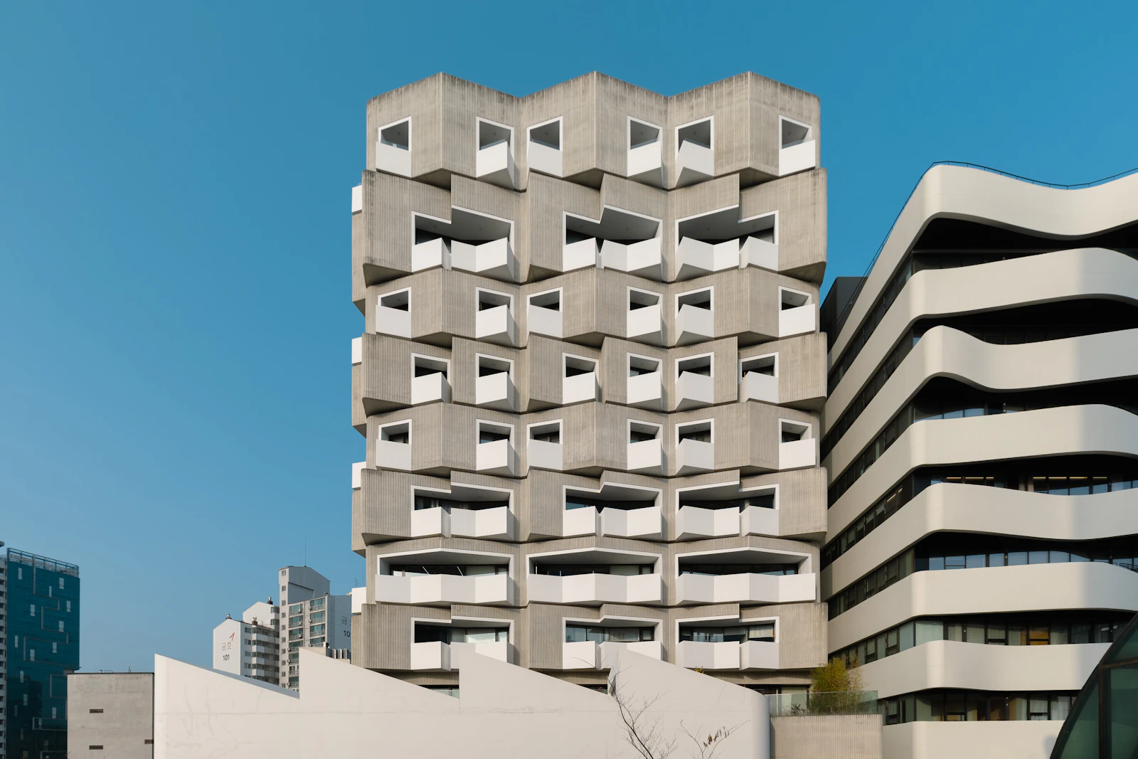 Concrete residential building with sculpted balconies