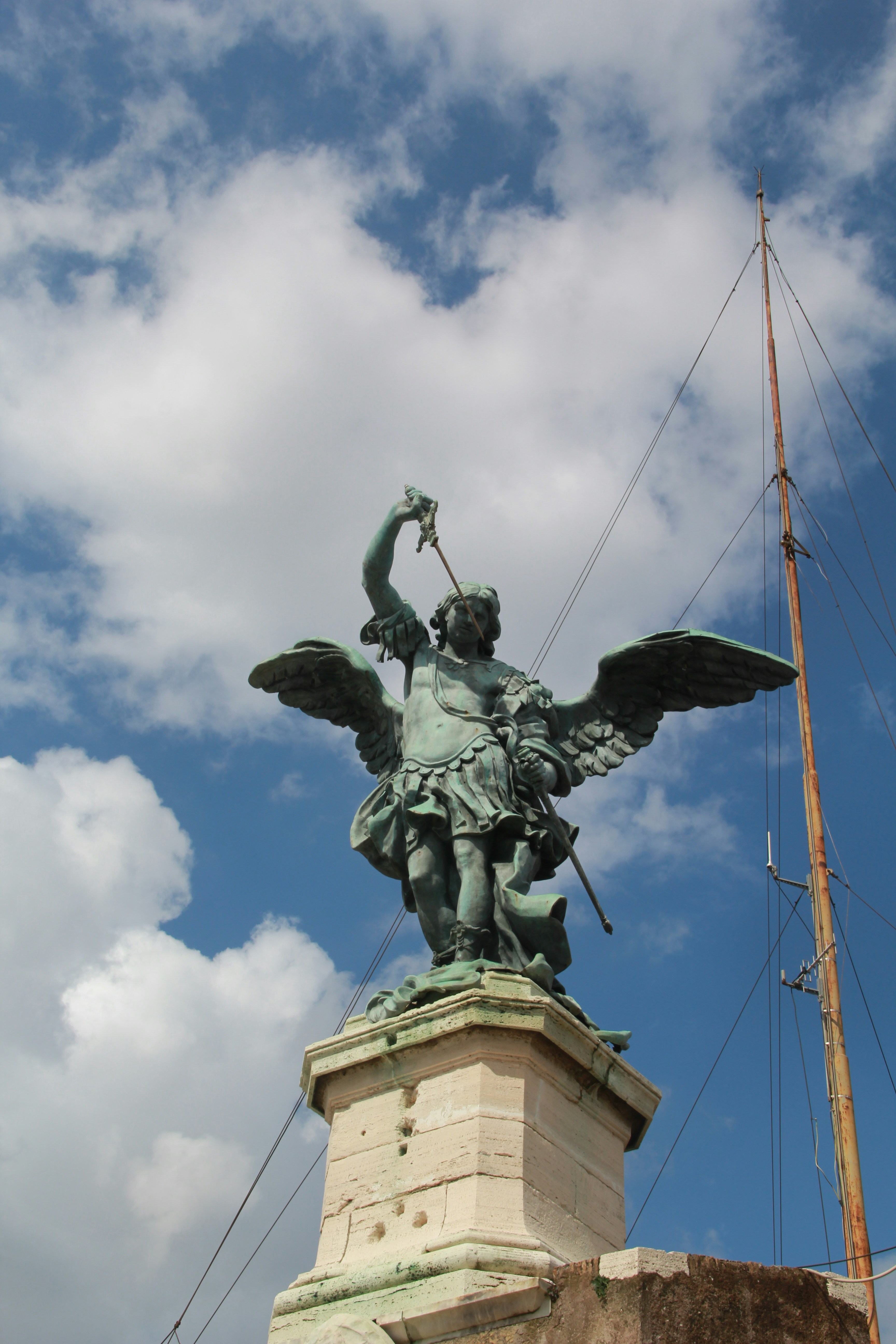 Statue of an angel with wings holding a sword