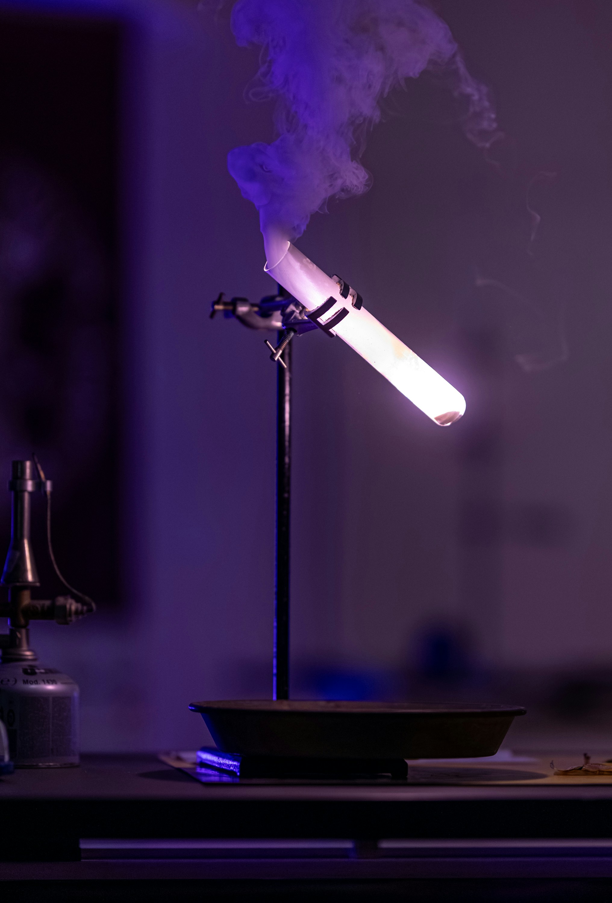 Chemical reaction producing smoke in a test tube.