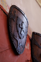 Wooden shield with metal cross emblem displayed