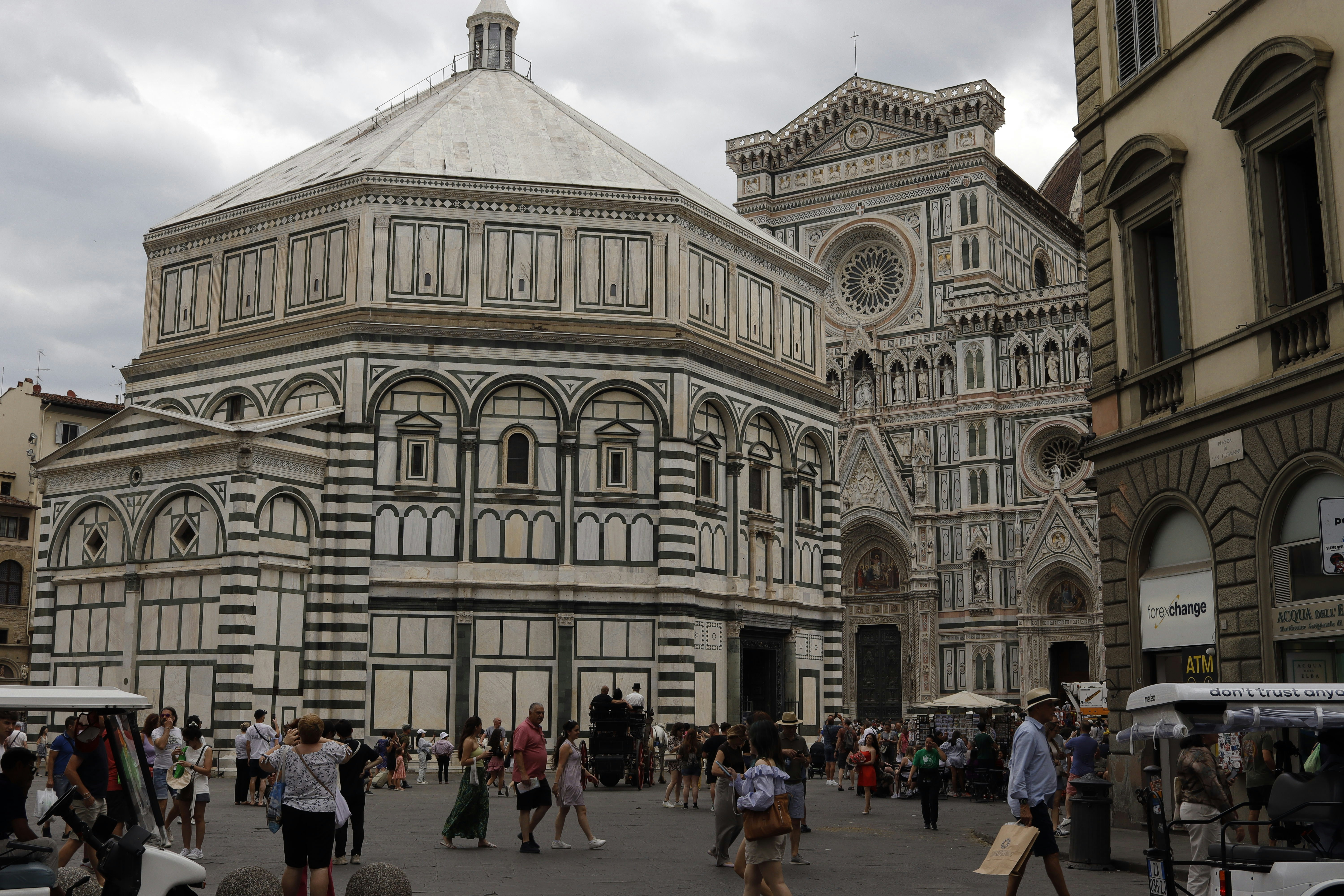 Ornate white marble buildings with people walking