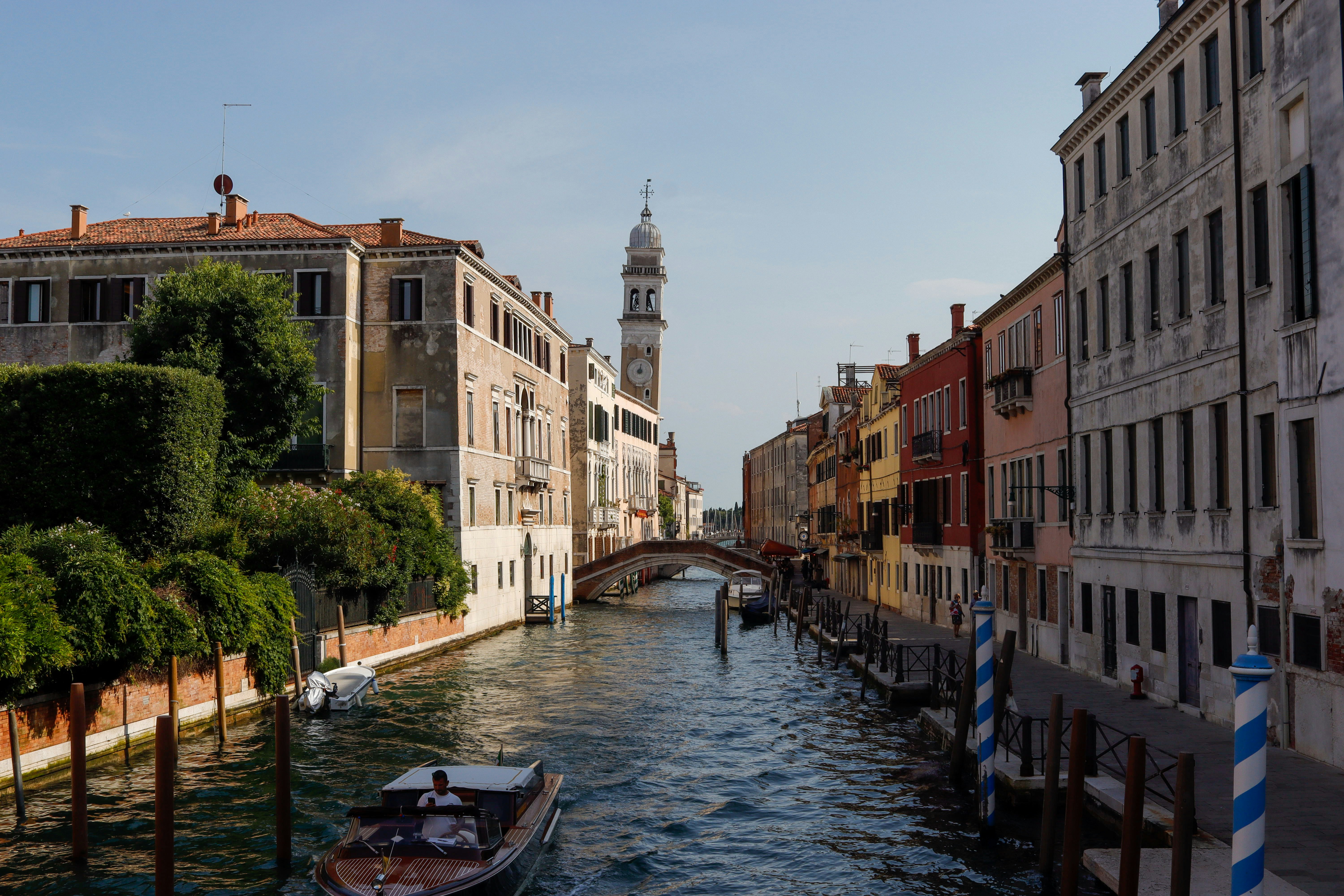 Canal in venice with buildings and a boat.