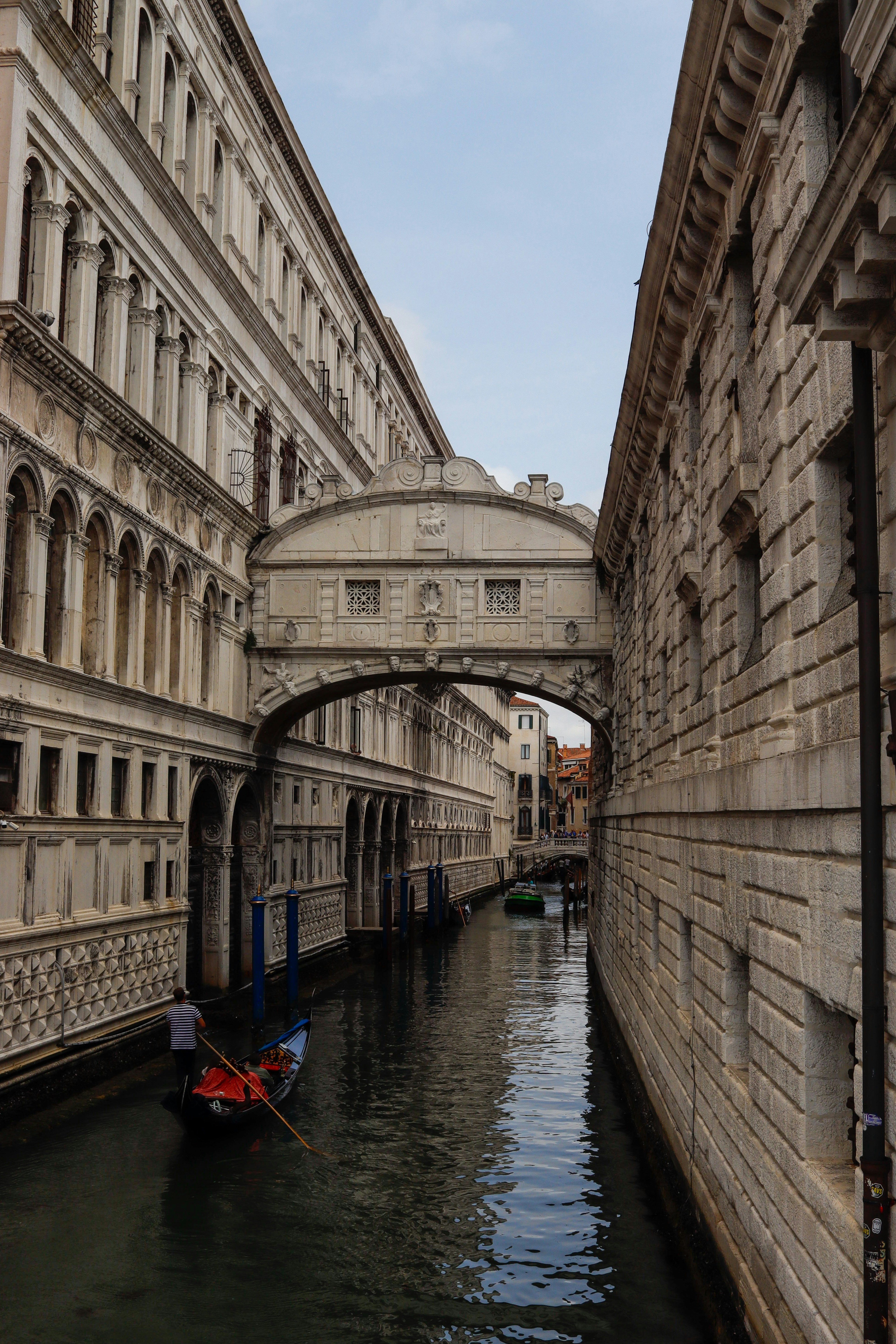Bridge of sighs over venetian canal with gondola