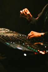 Dj hands mixing music on a soundboard
