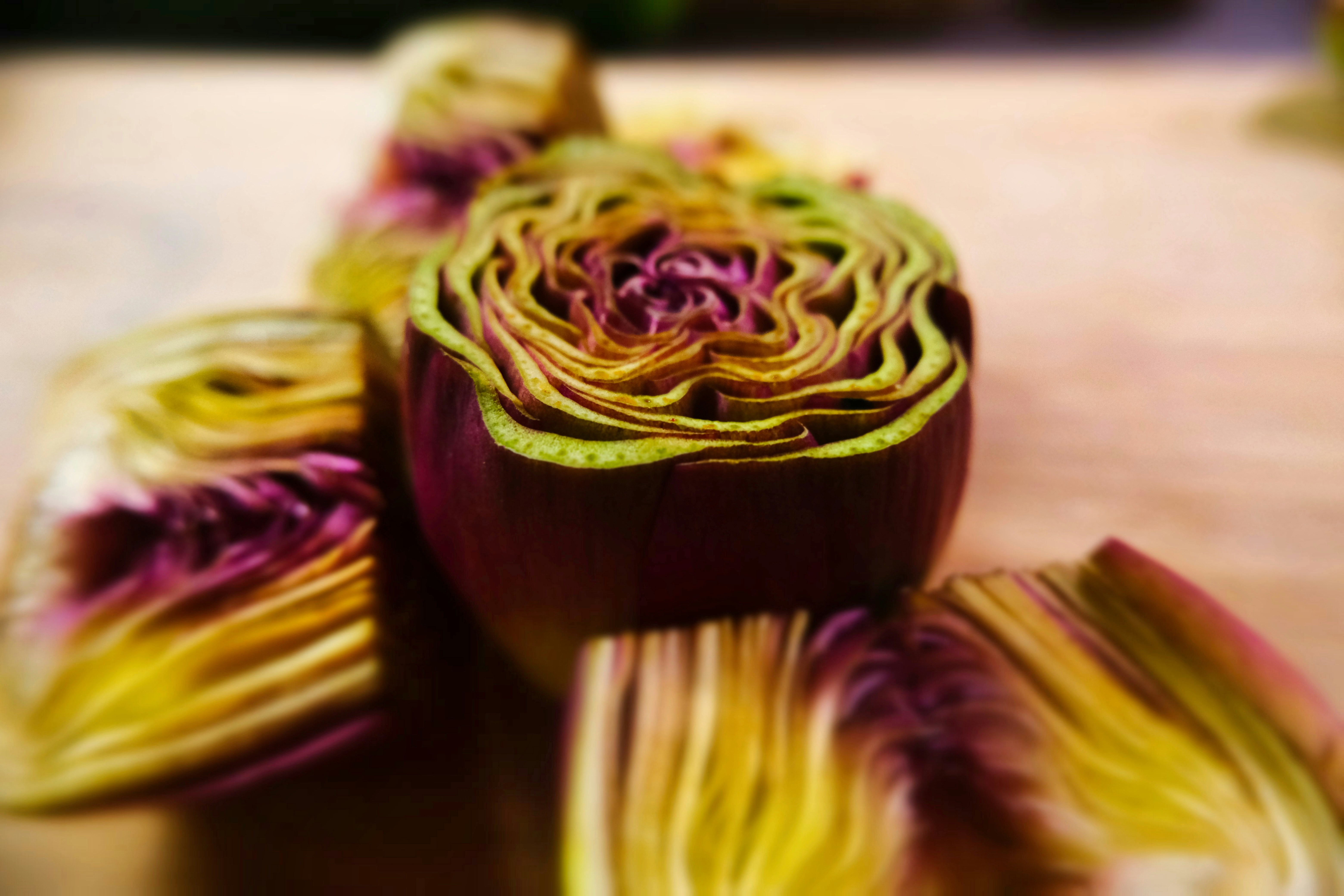 Close-up of a sliced artichoke with purple and yellow layers.