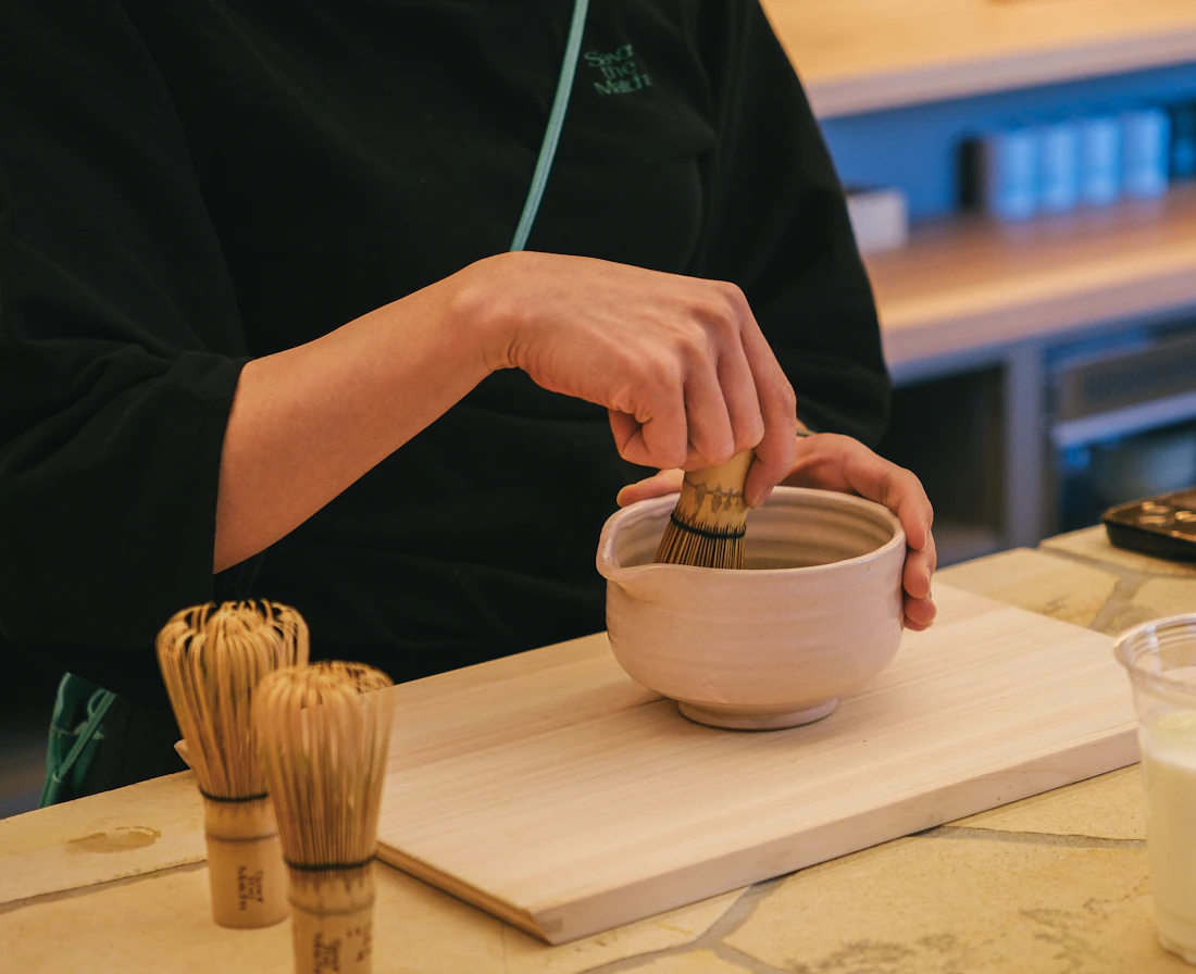 Hands preparing a botanical tea ritual