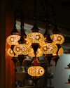 A decorative mosaic glass chandelier with multiple lights.