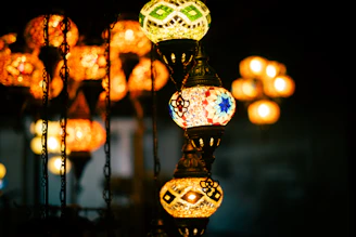 Colorful mosaic lanterns hanging in the dark