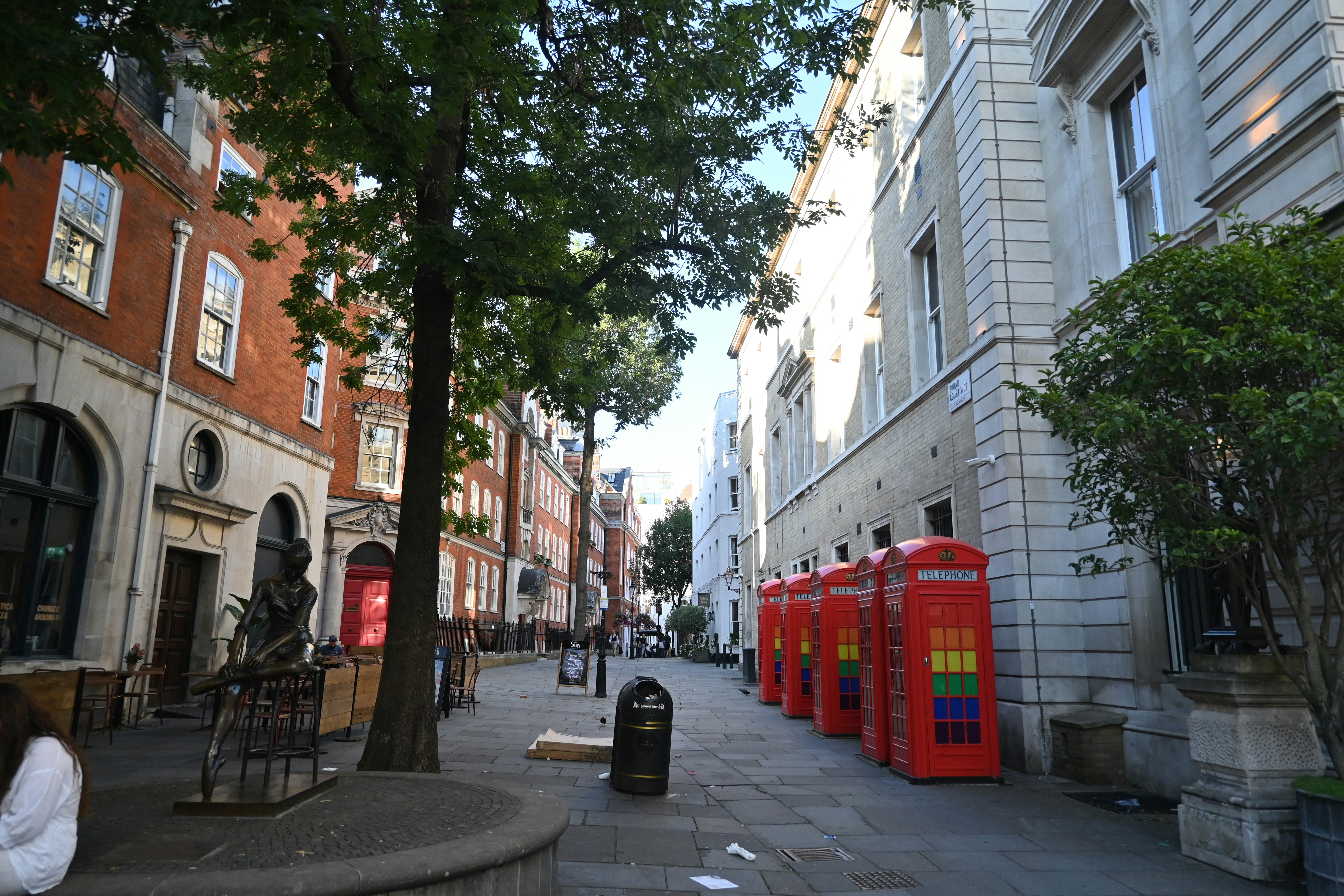 Red phone booths line a city street