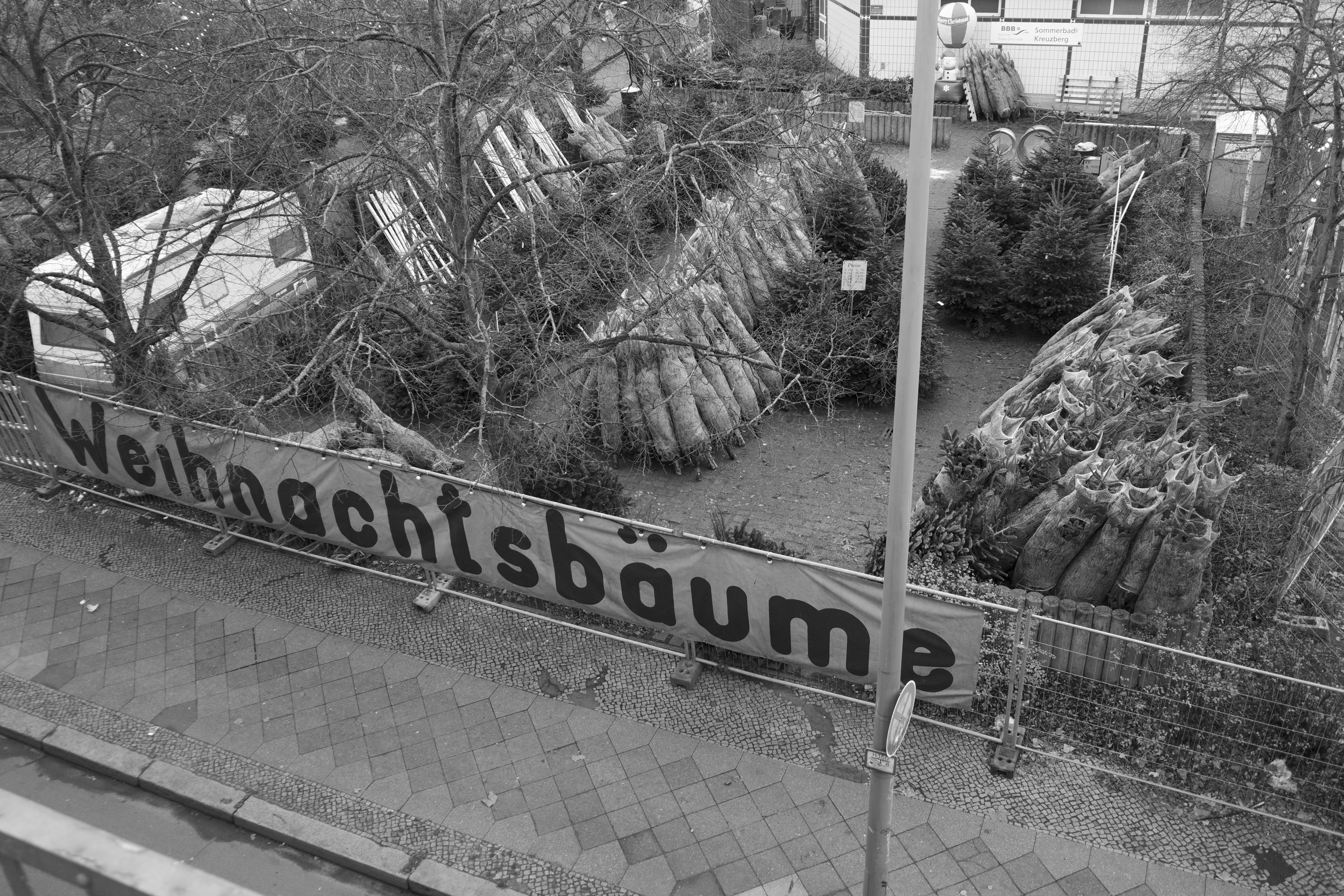 Christmas trees for sale with "weihnachtsbaume" sign.