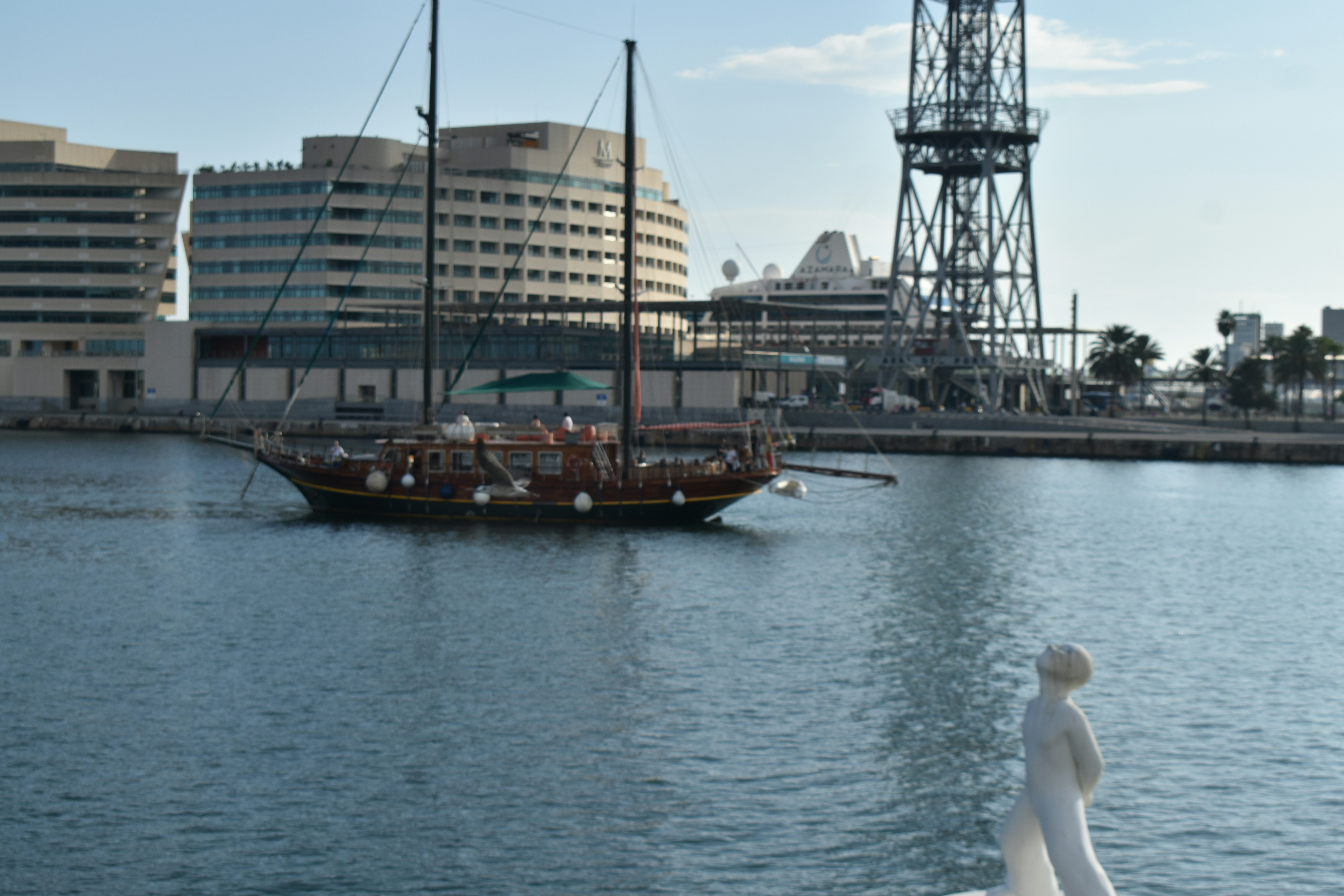 Sailboat on the water near buildings and tower