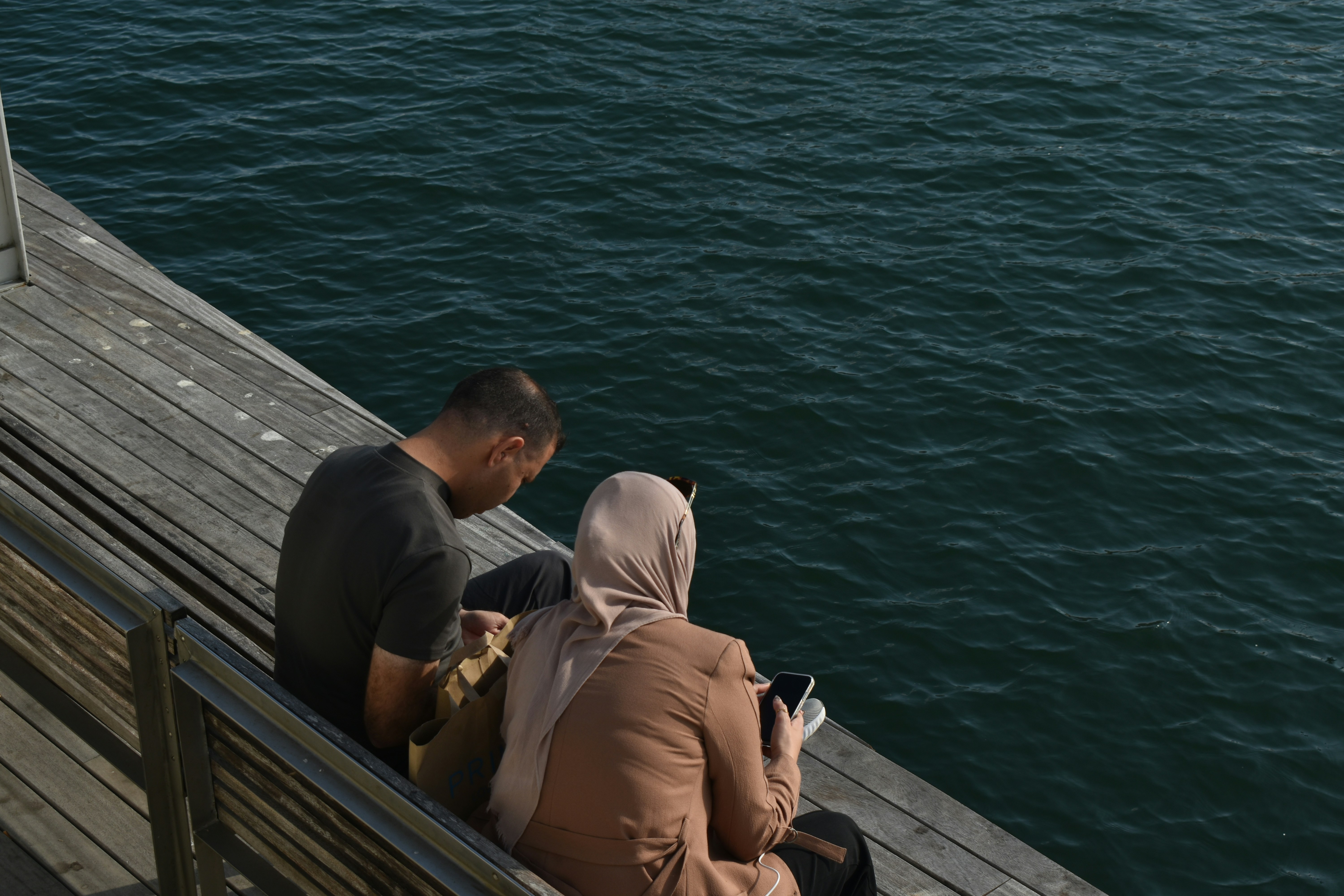 Couple sitting by the water