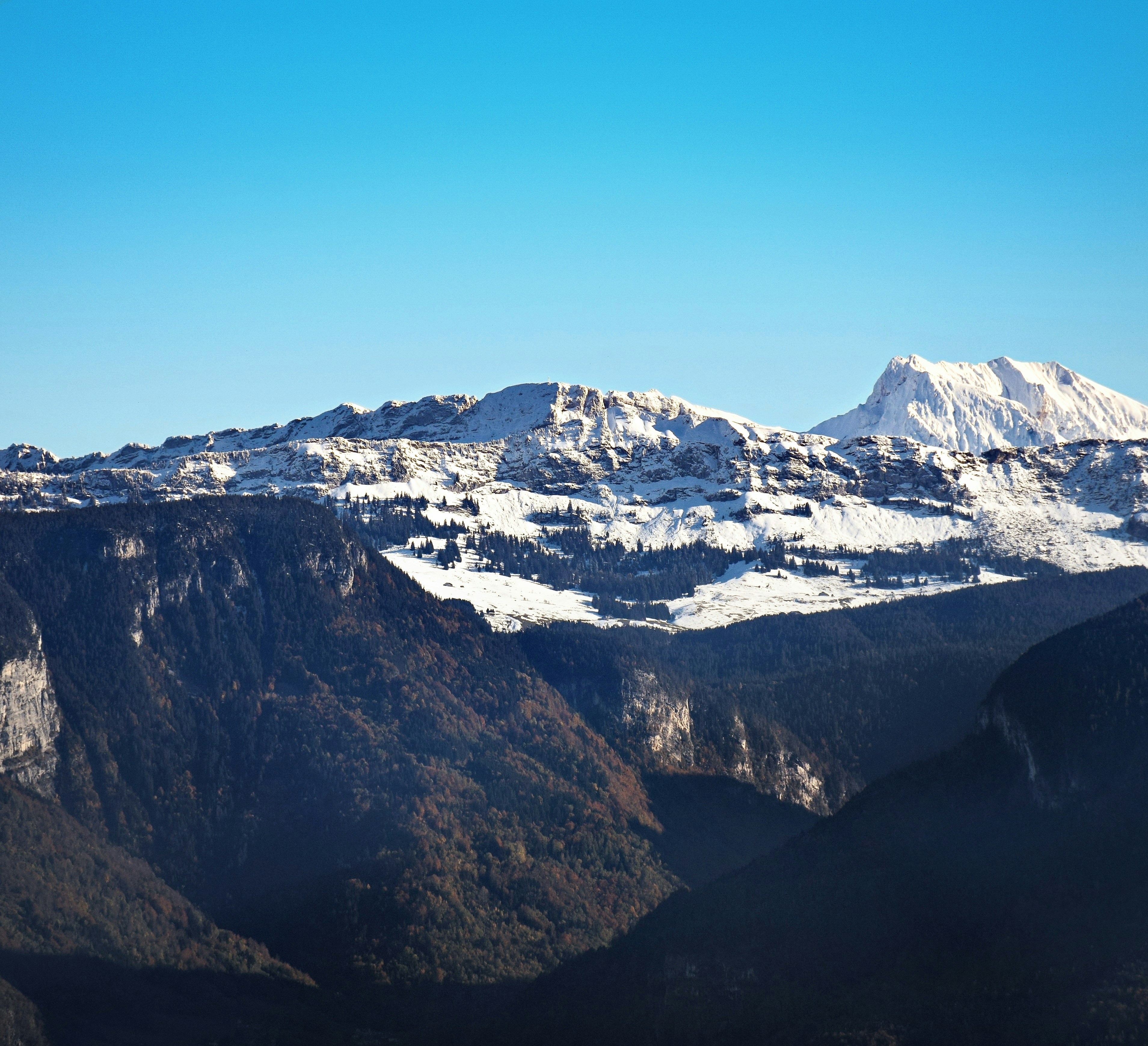Snow-capped mountains under a clear blue sky