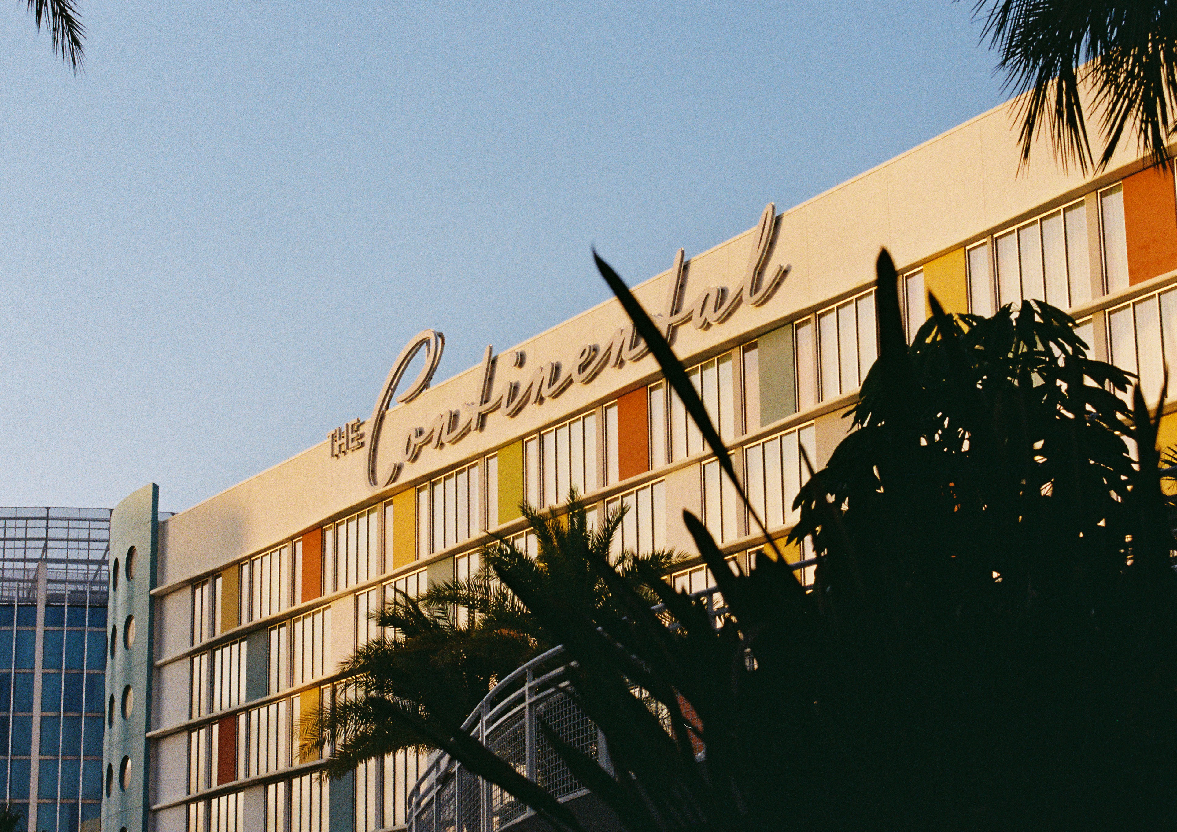 The continental hotel with colorful windows and palm trees.