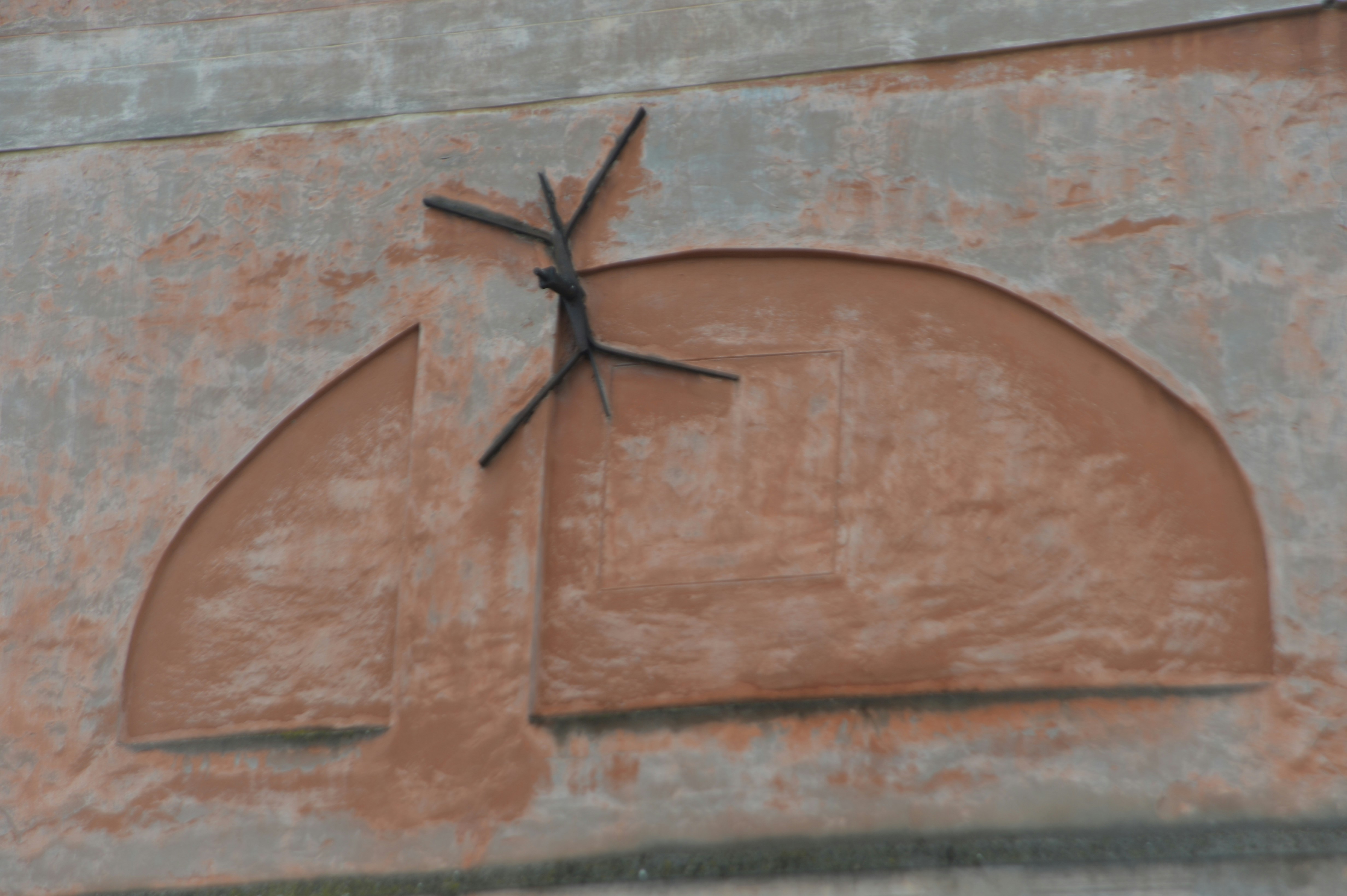 Architectural detail with a semicircular element and metal fixture.
