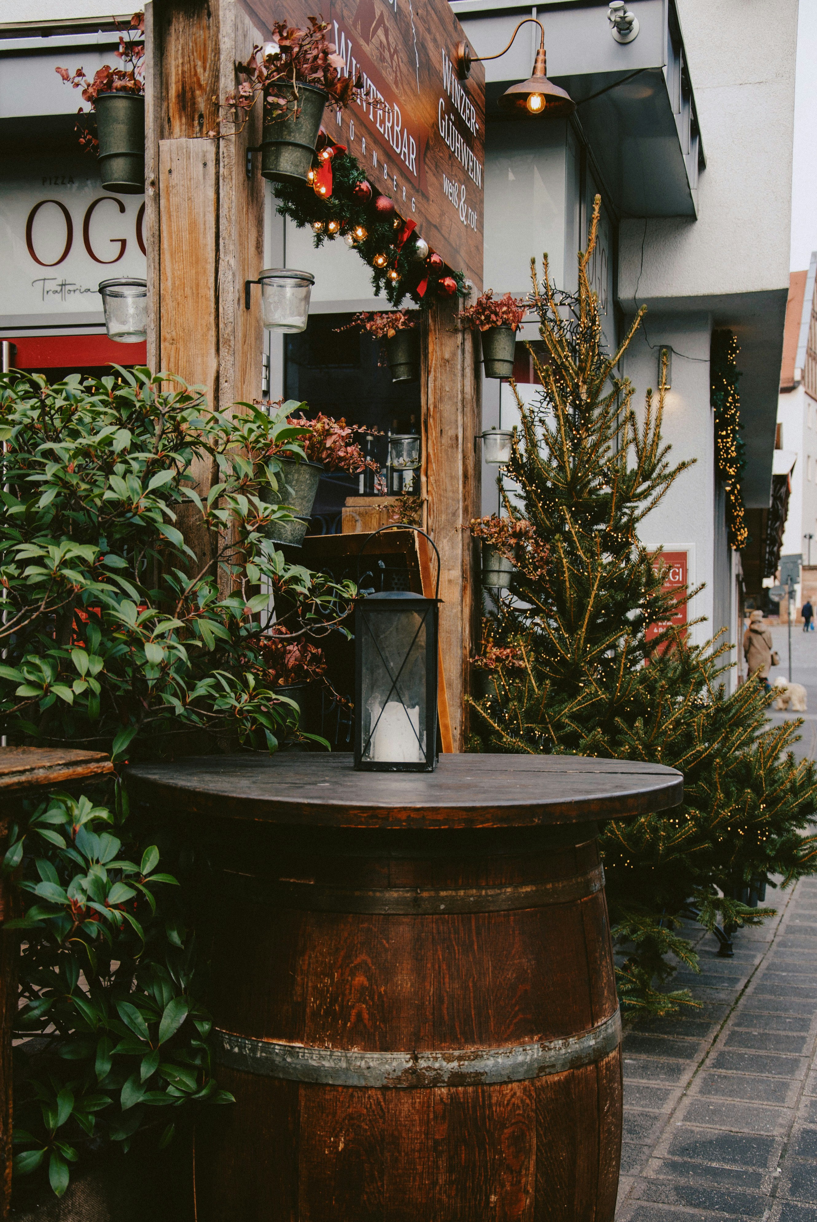 Outdoor seating area with barrel table and christmas trees