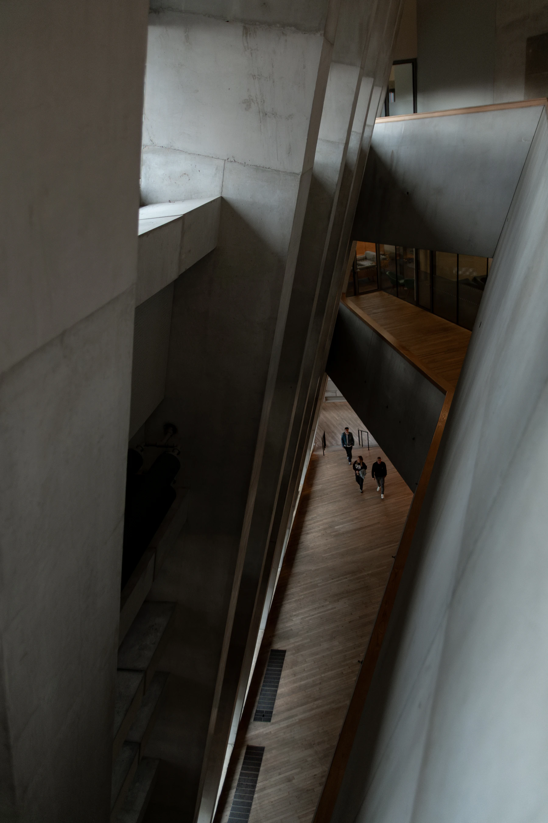 Visitors walking through a spacious, high-ceilinged modern museum gallery