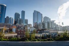 Modern city skyline with tall buildings under clear sky.
