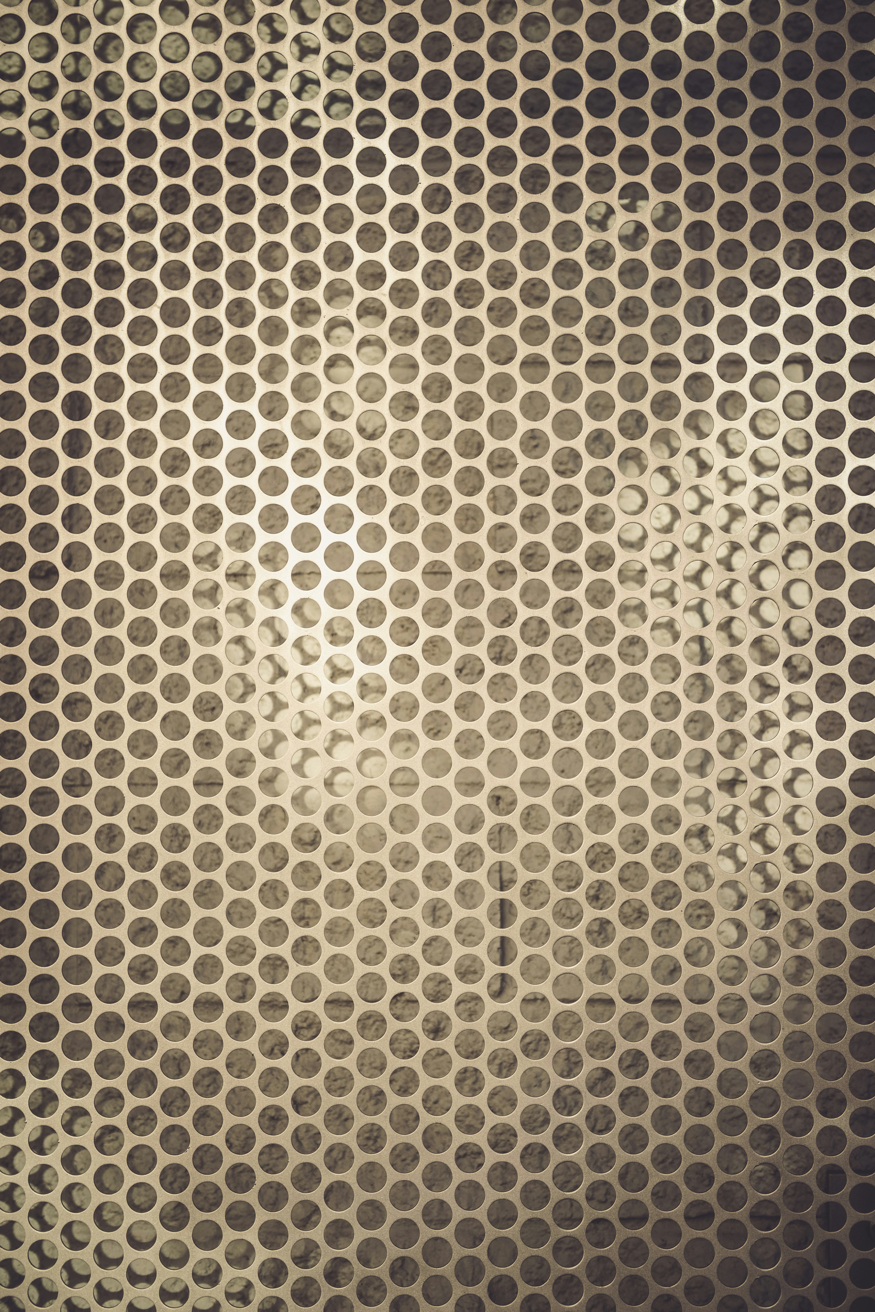 Perforated metal grid with textured background