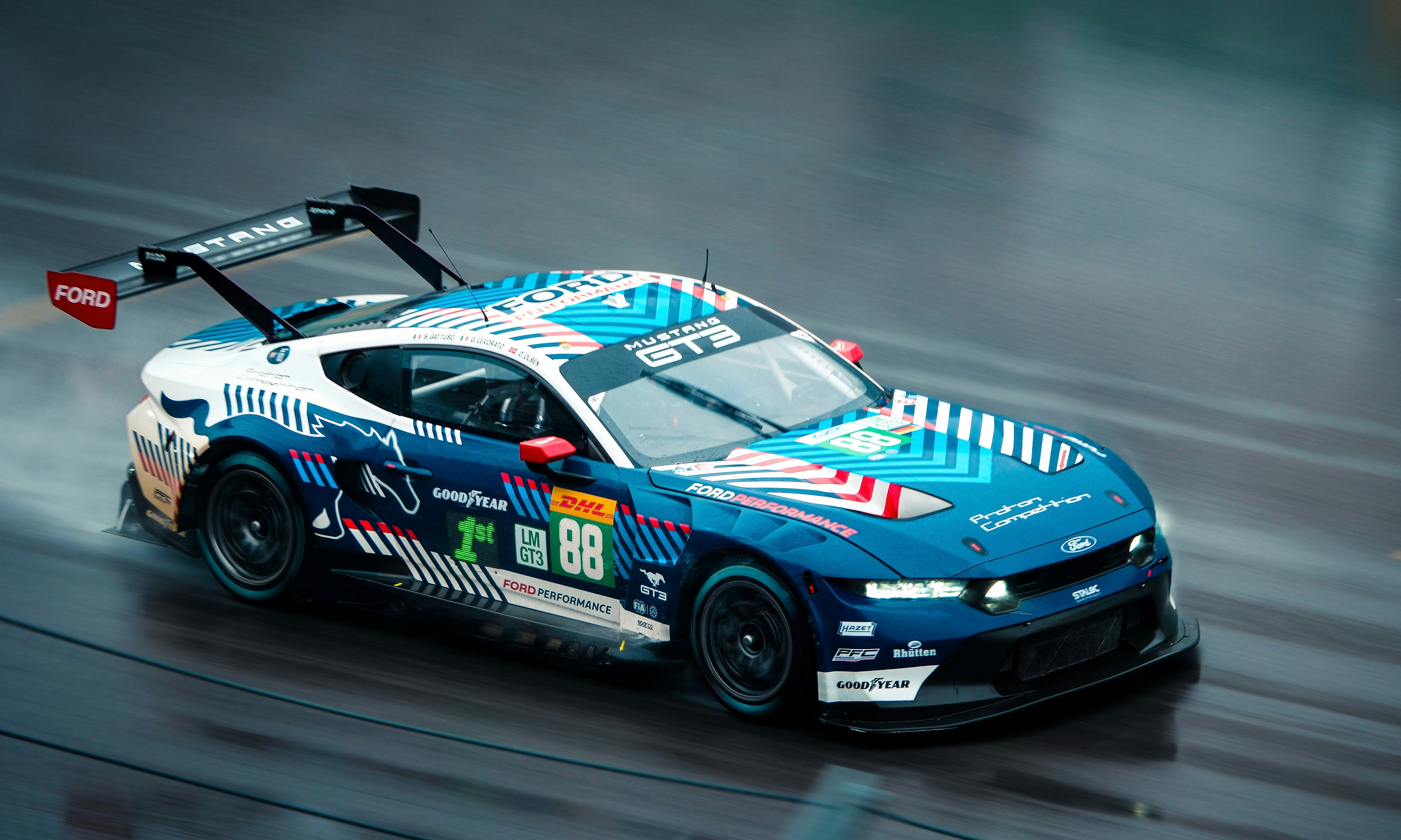 Race car with blue and white livery on track