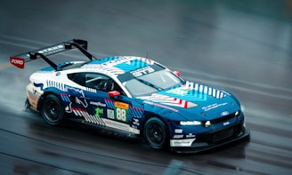 Race car with blue and white livery on track