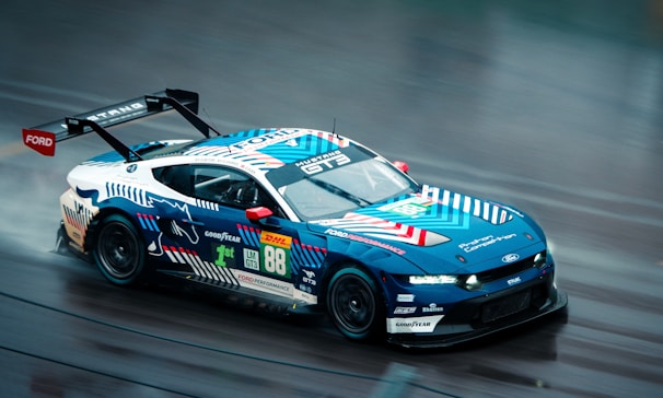 Race car with blue and white livery on track