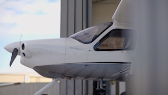 White airplane parked in a hangar