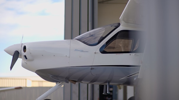 White airplane parked in a hangar
