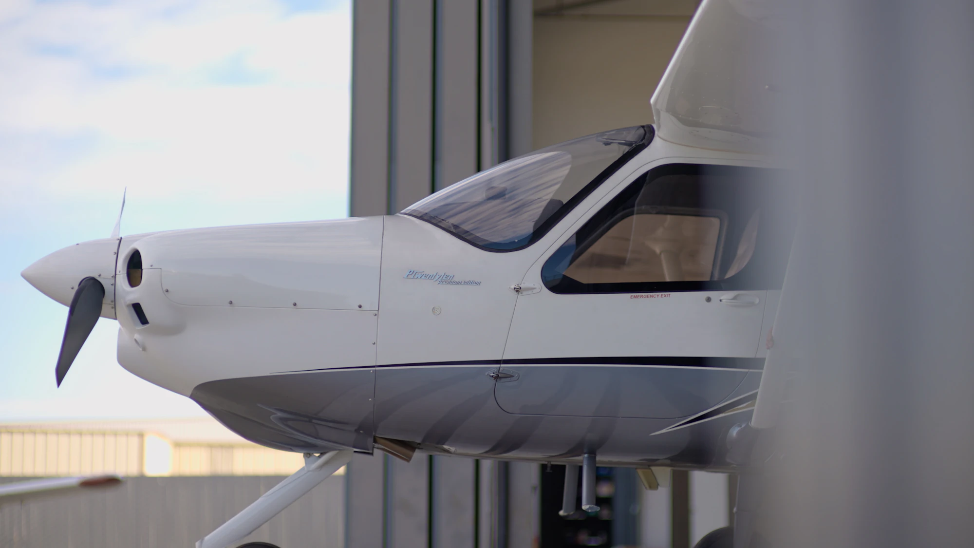 Light aircraft parked inside a maintenance hangar