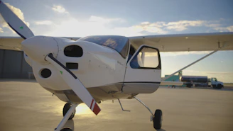 Small airplane with open door on tarmac