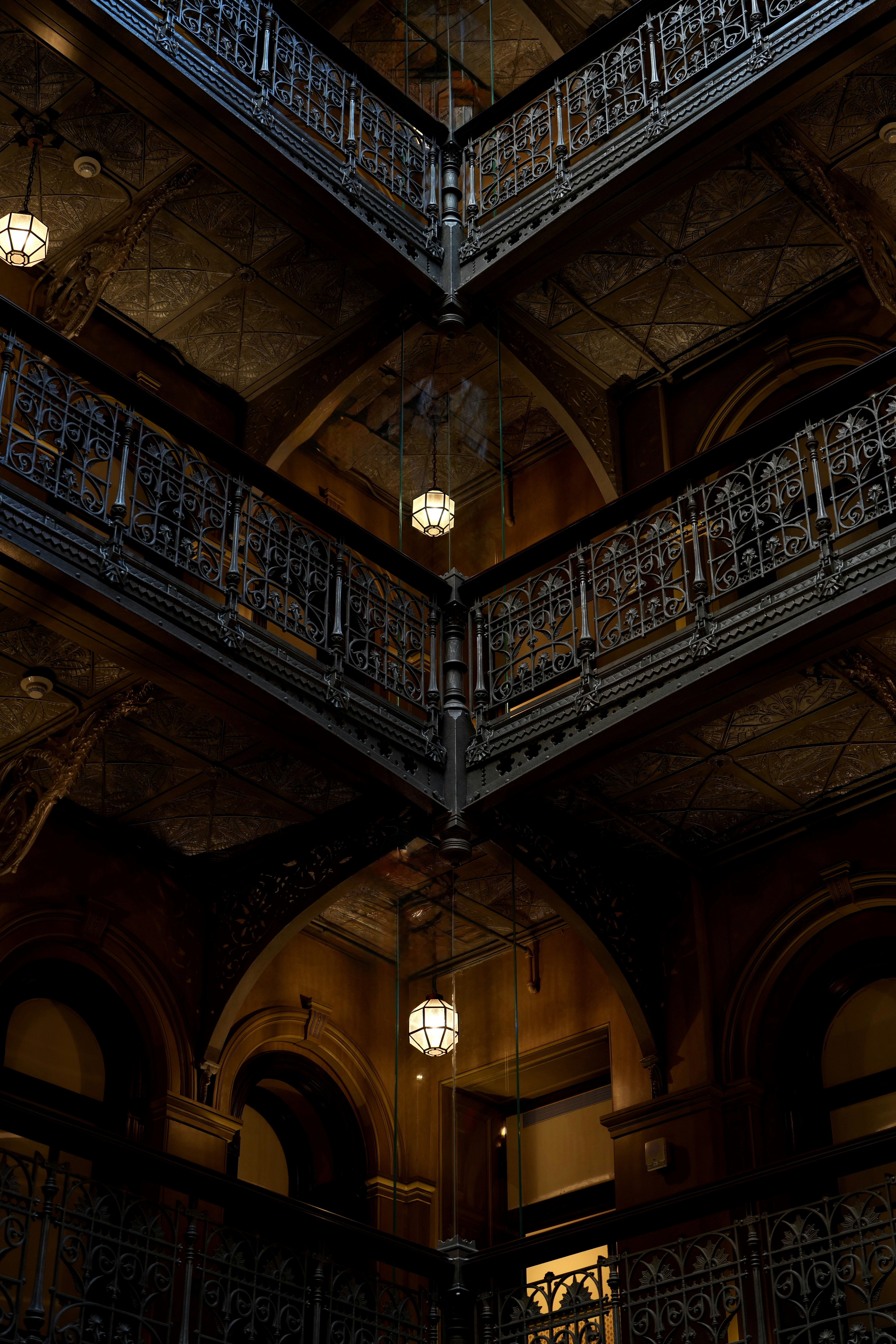 Ornate balconies overlook a dimly lit atrium.