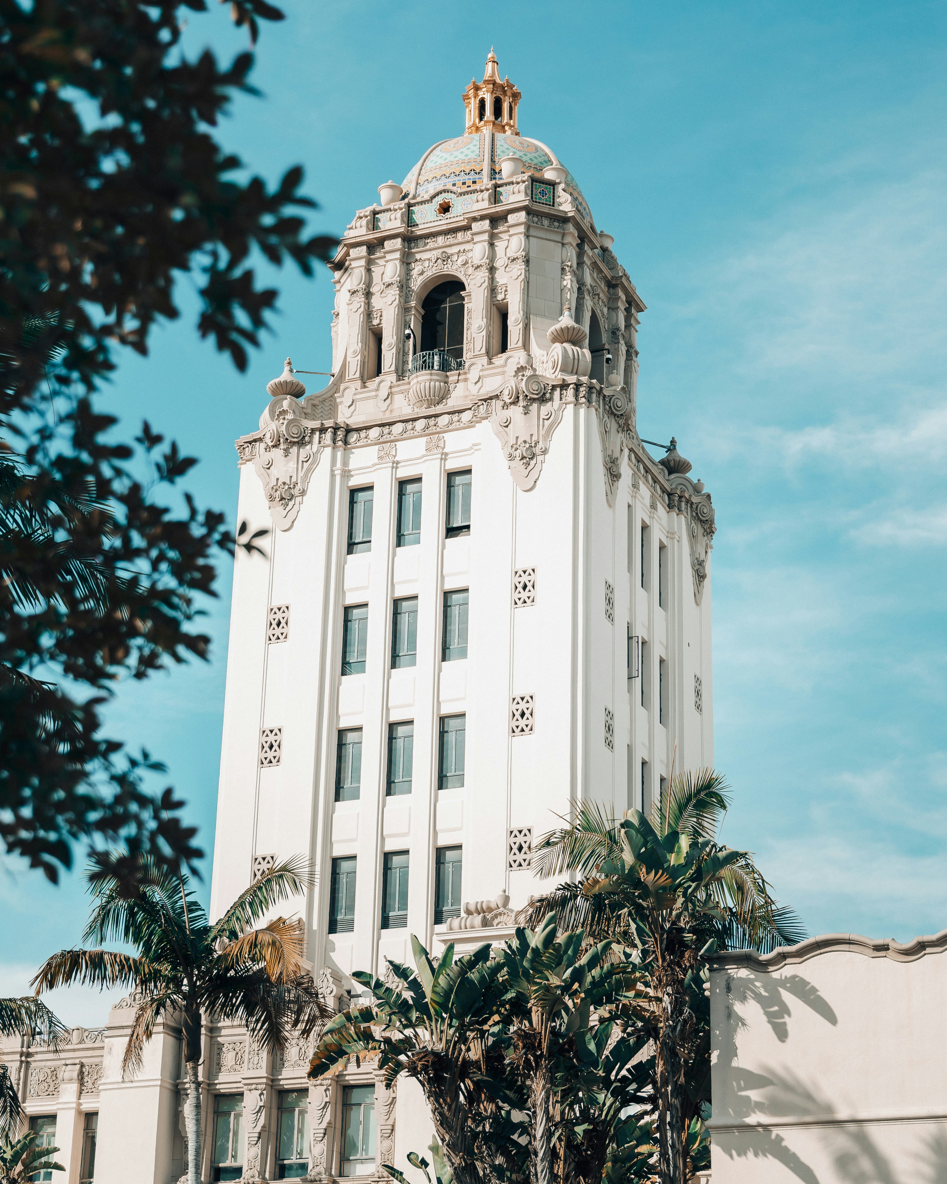 Ornate white building with palm trees and blue sky