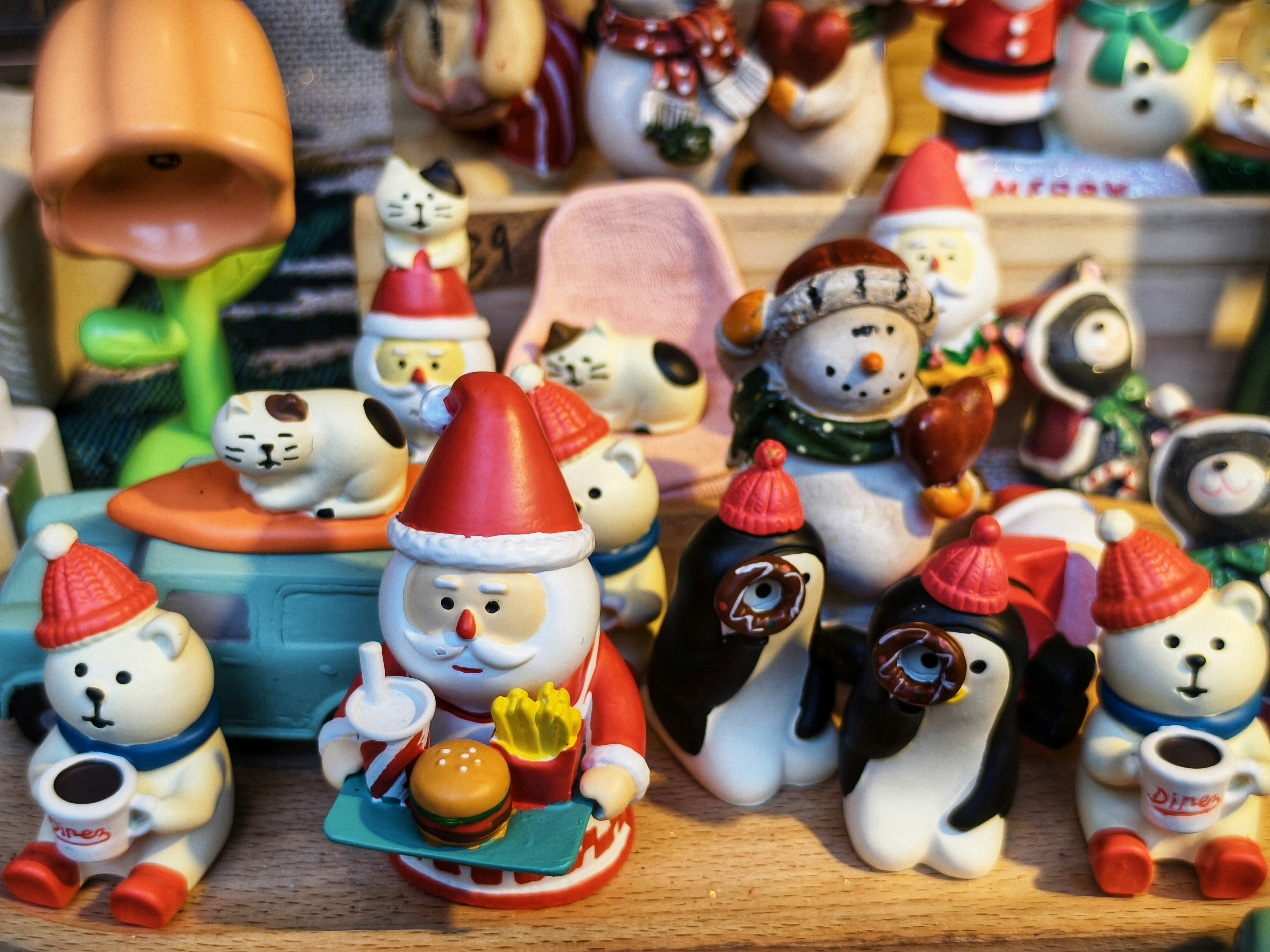 Collection of festive christmas figurines including santa and penguins.