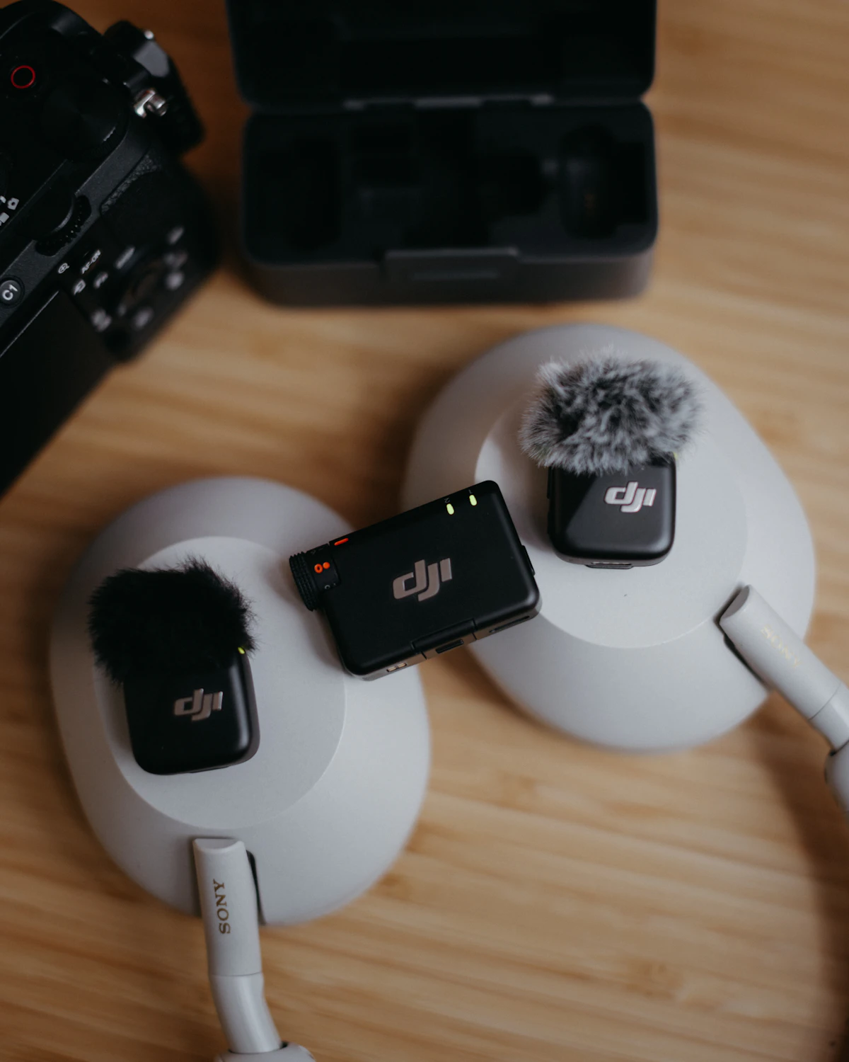 Wireless microphones and camera equipment laid out on a table