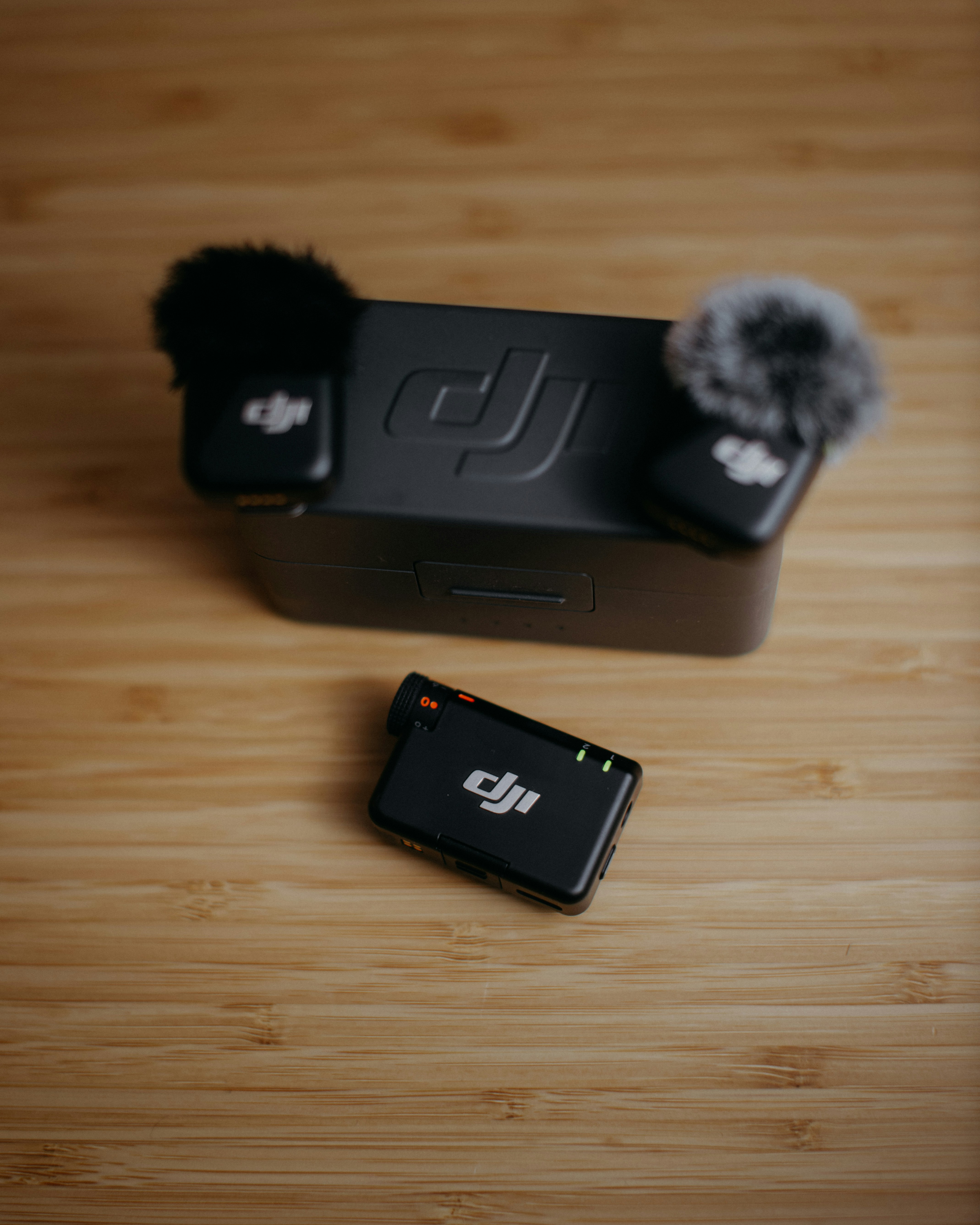 Two dji wireless microphones and charging case