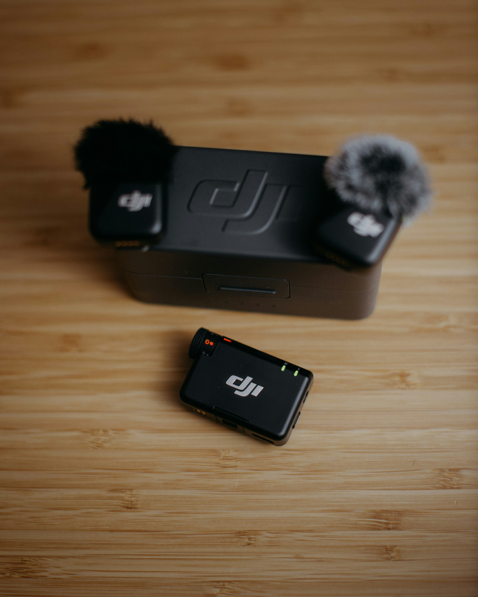 Two dji wireless microphones and charging case