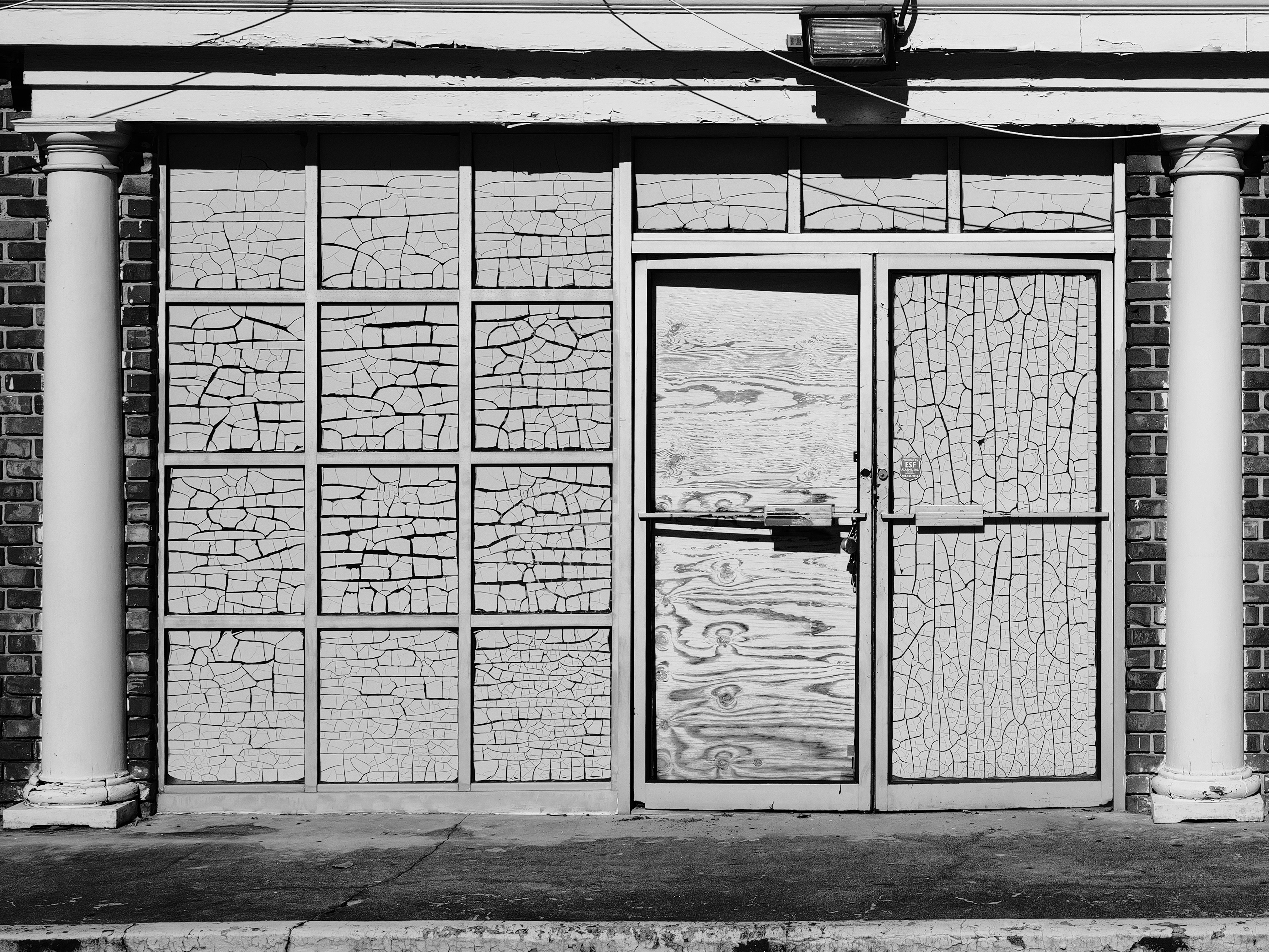 Cracked paint on old building facade with columns
