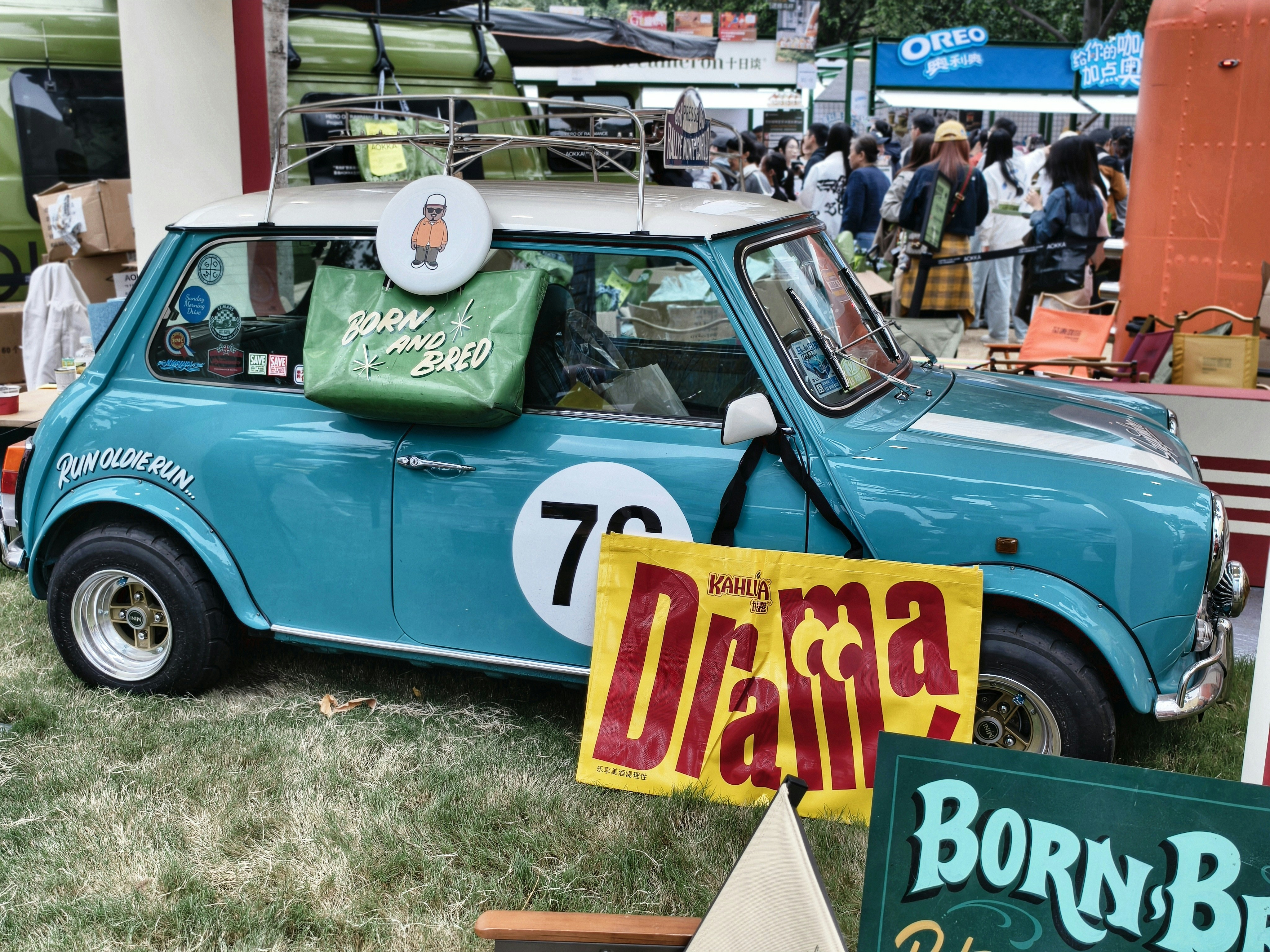 Blue vintage mini cooper with "drama" sign
