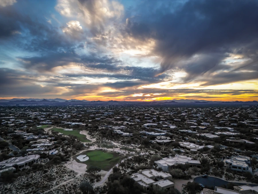 Dramatic sunset over desert neighborhoods and mountains