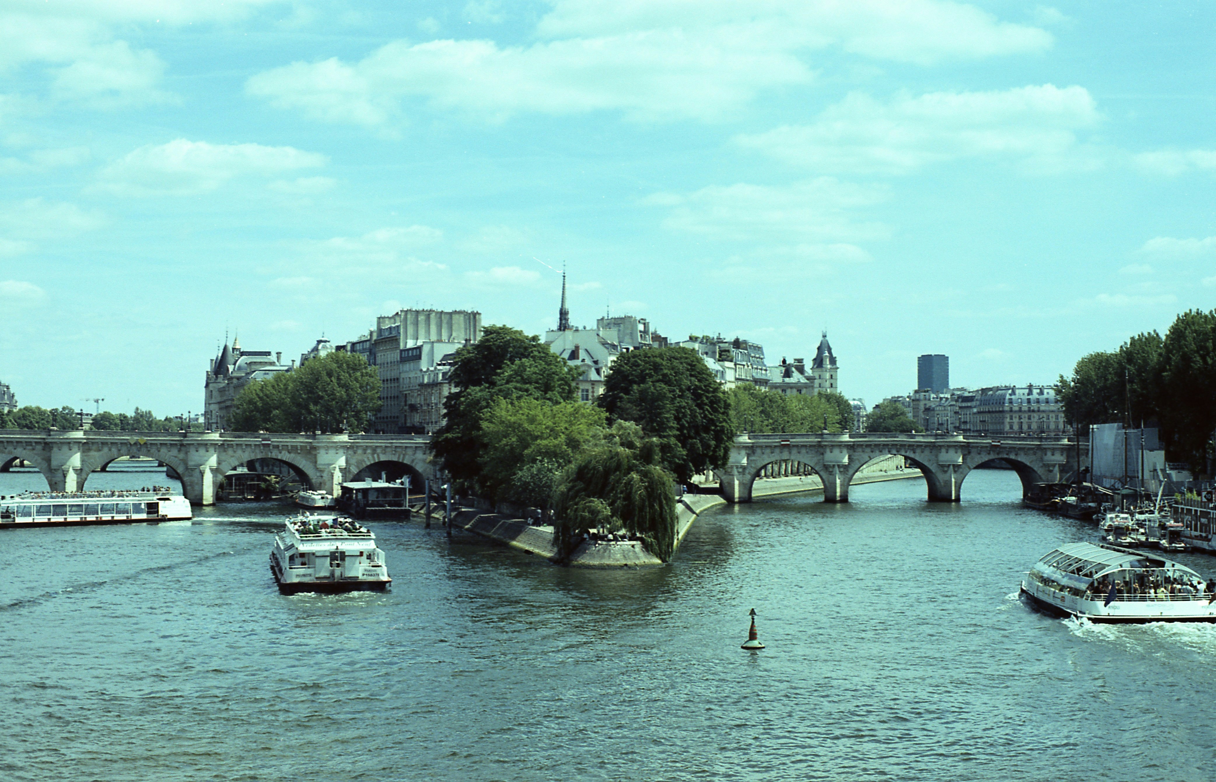 Boats on the seine river with bridges and buildings