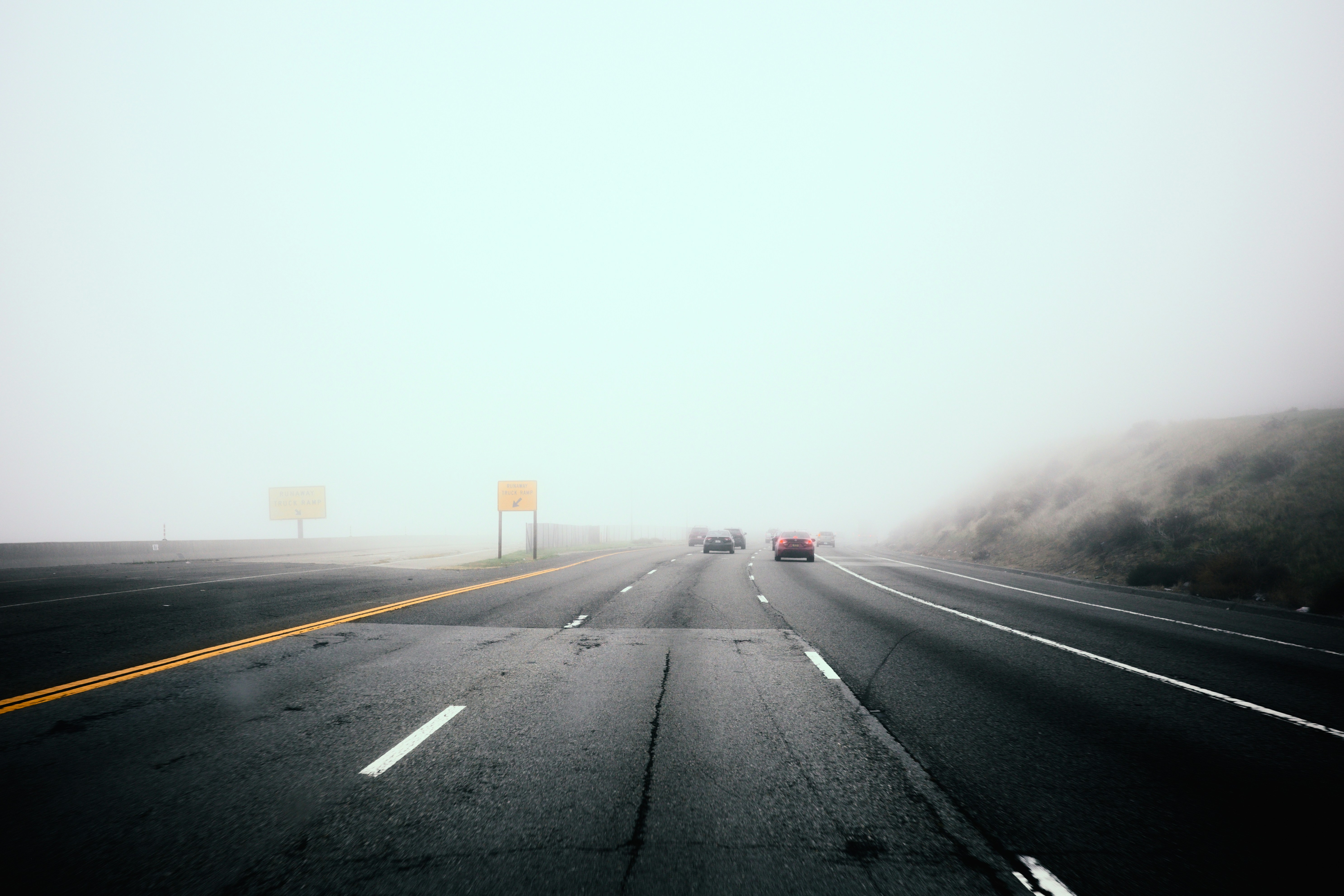 Cars driving on a foggy highway