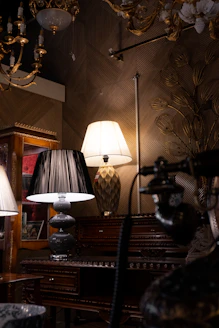 Antique lamps on a dark wooden desk.
