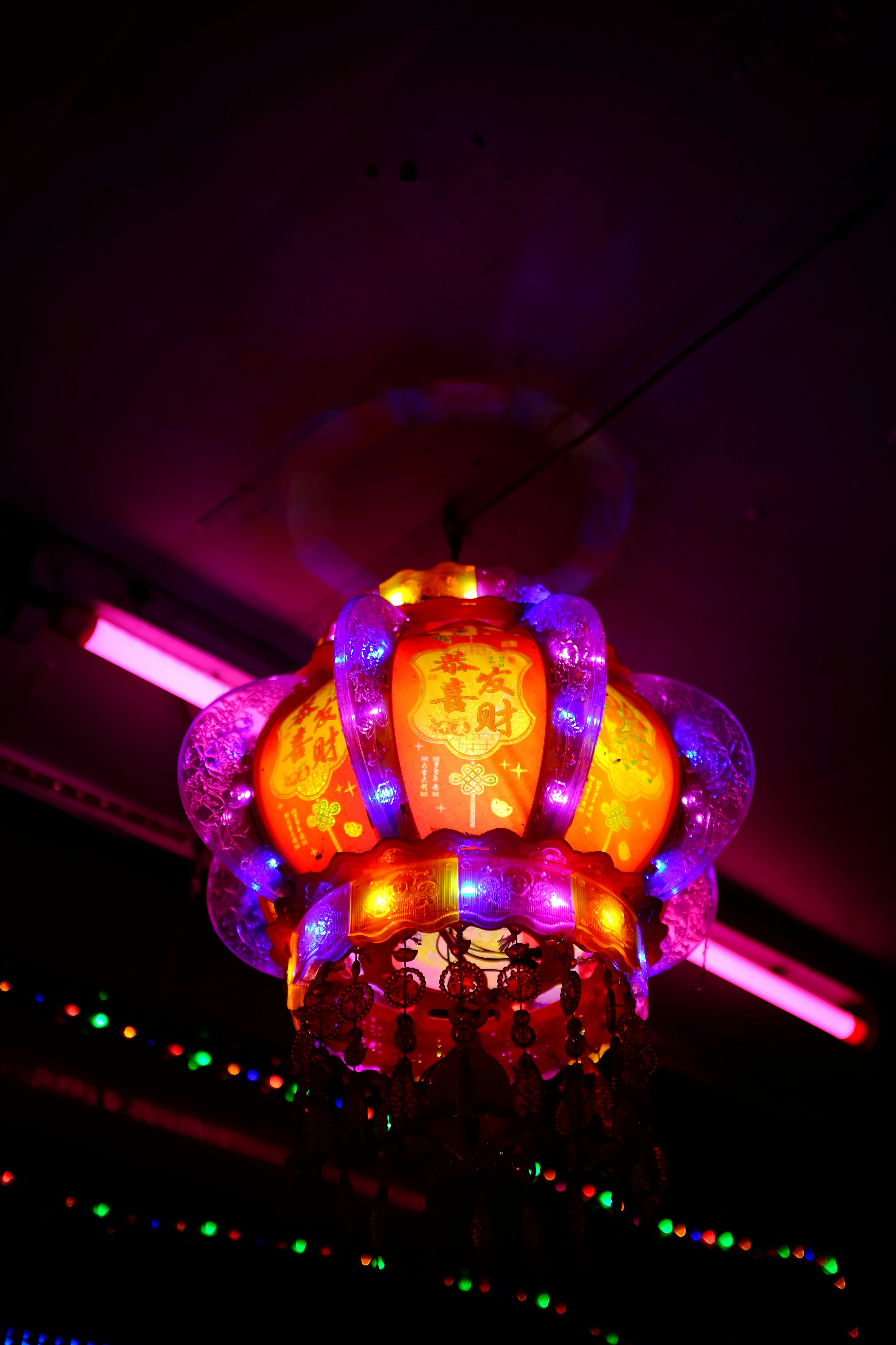 A colorful lantern illuminated with purple and orange lights.