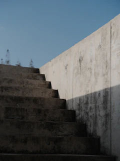 Concrete stairs ascend against a clear blue sky
