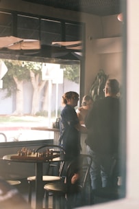 People talking inside a cafe with a chessboard