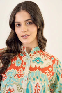 A woman wearing a colorful patterned shirt