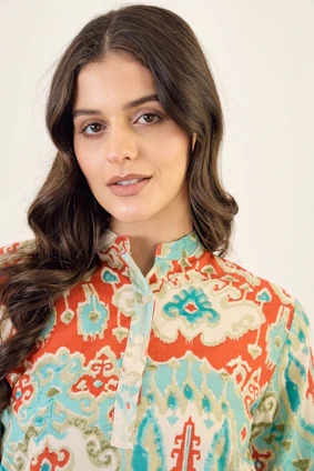 A woman wearing a colorful patterned shirt