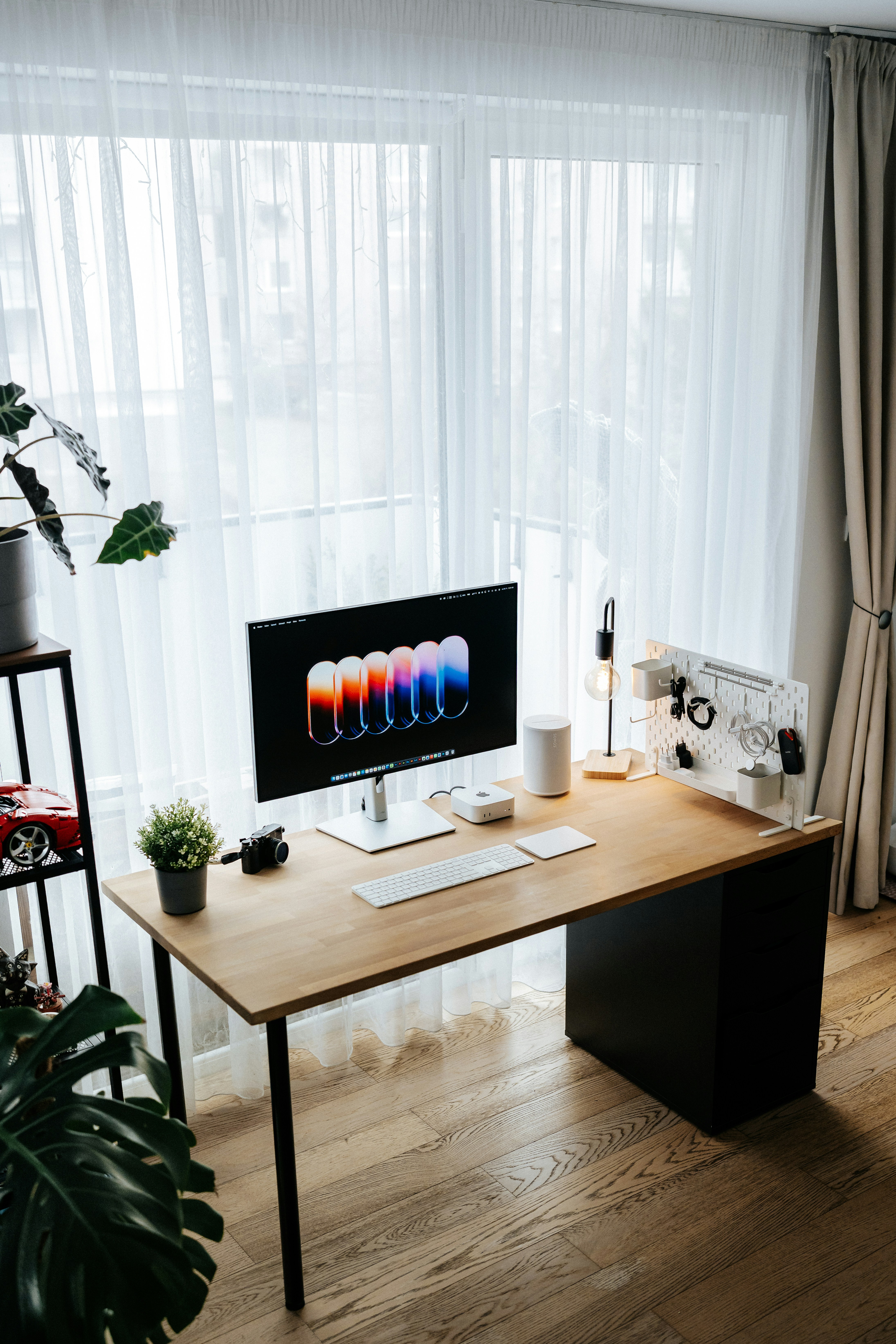 Modern desk with computer and minimalist decor.
