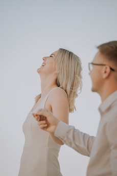 Couple laughing and holding hands outdoors