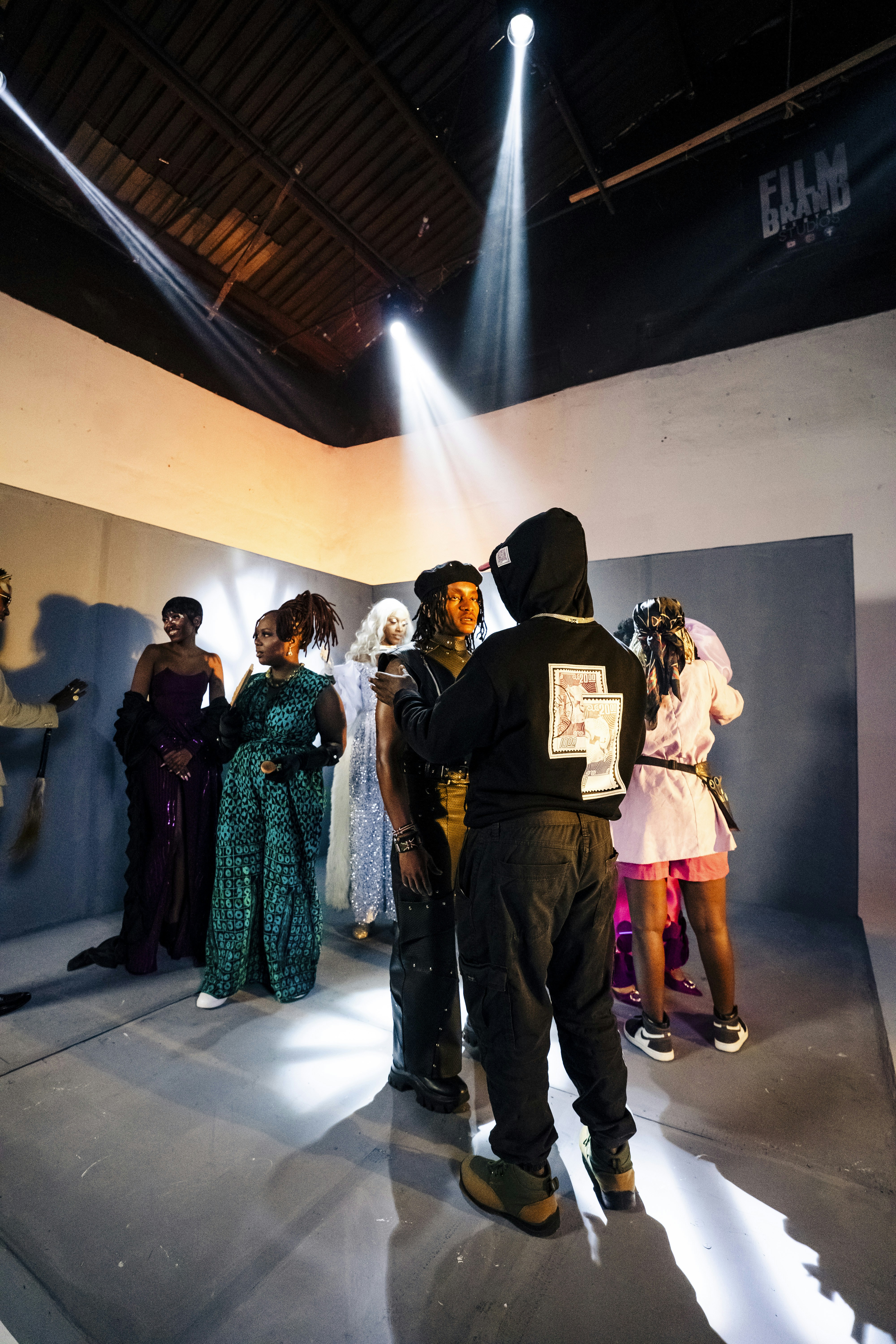 Models posing for a photoshoot under studio lights.